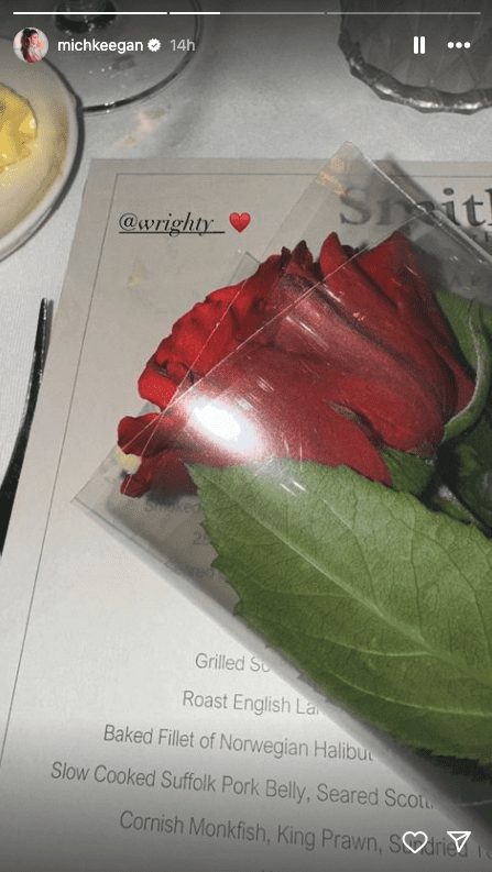 A rose sitting on a restaurant menu