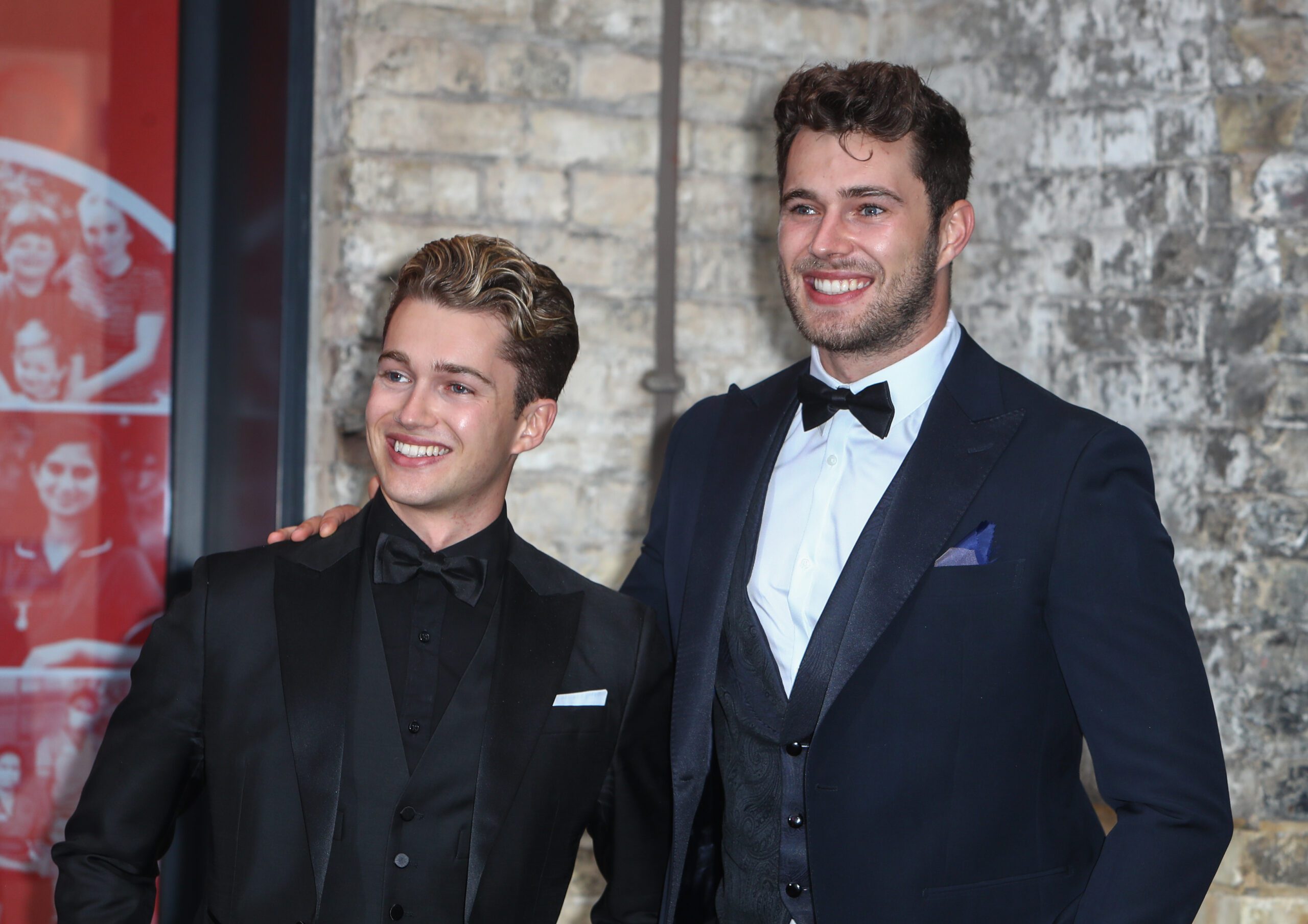 AJ with his brother Curtis Pritchard smiling for photos at the Sun's Who Cares Wins Awards in 2021