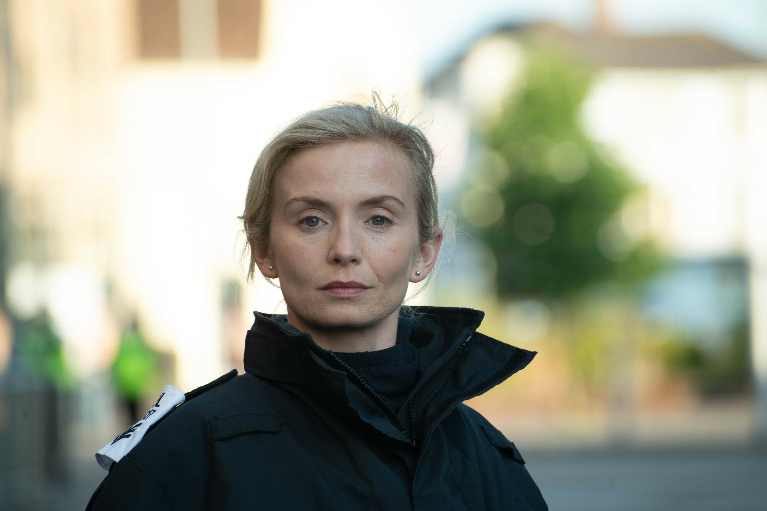 The Way cast: Sophie Melville as Thea, wearing black, looking straight at the camera