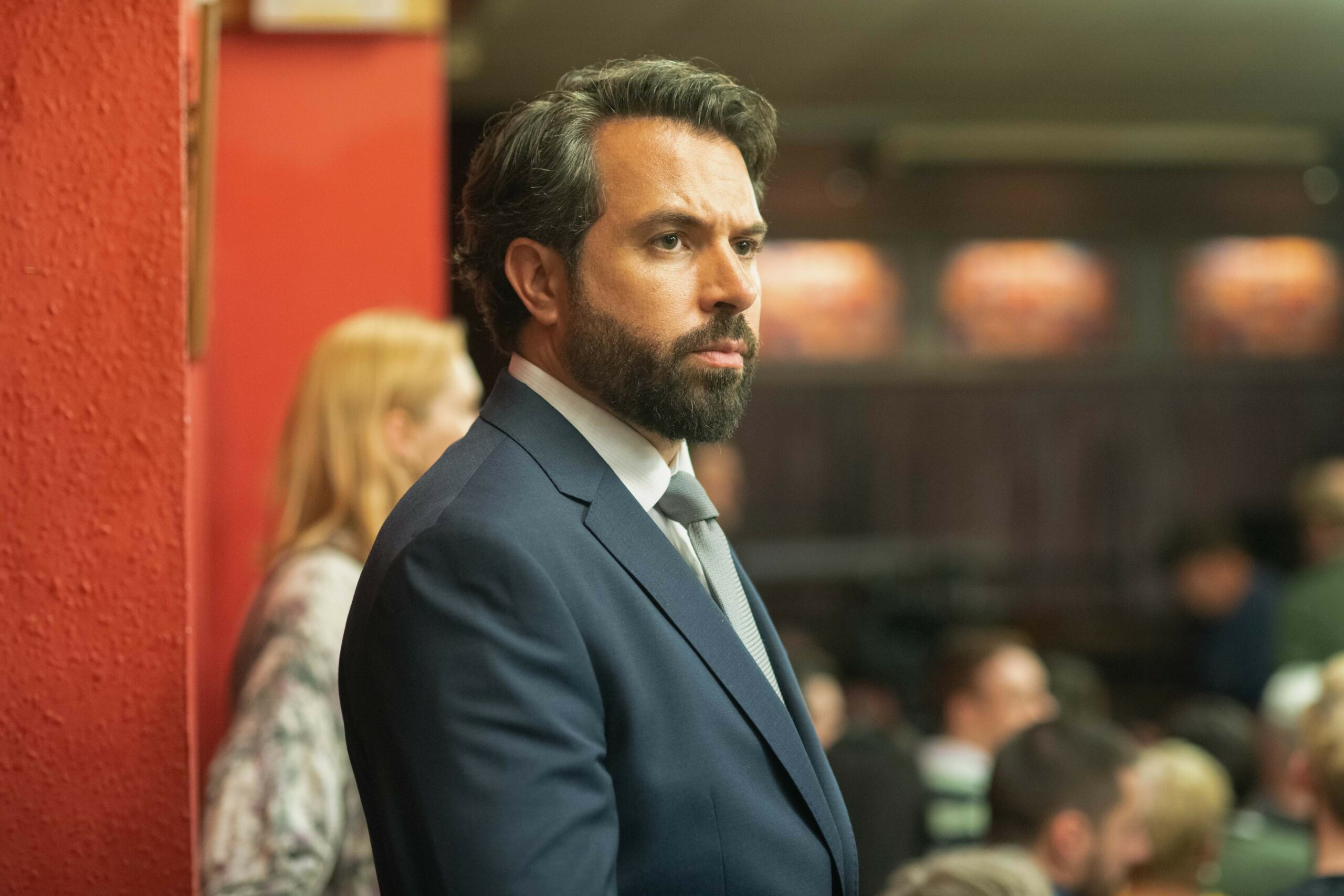The Way cast: Tom Cullen as Jack Price MP, staring out at a crowd of people