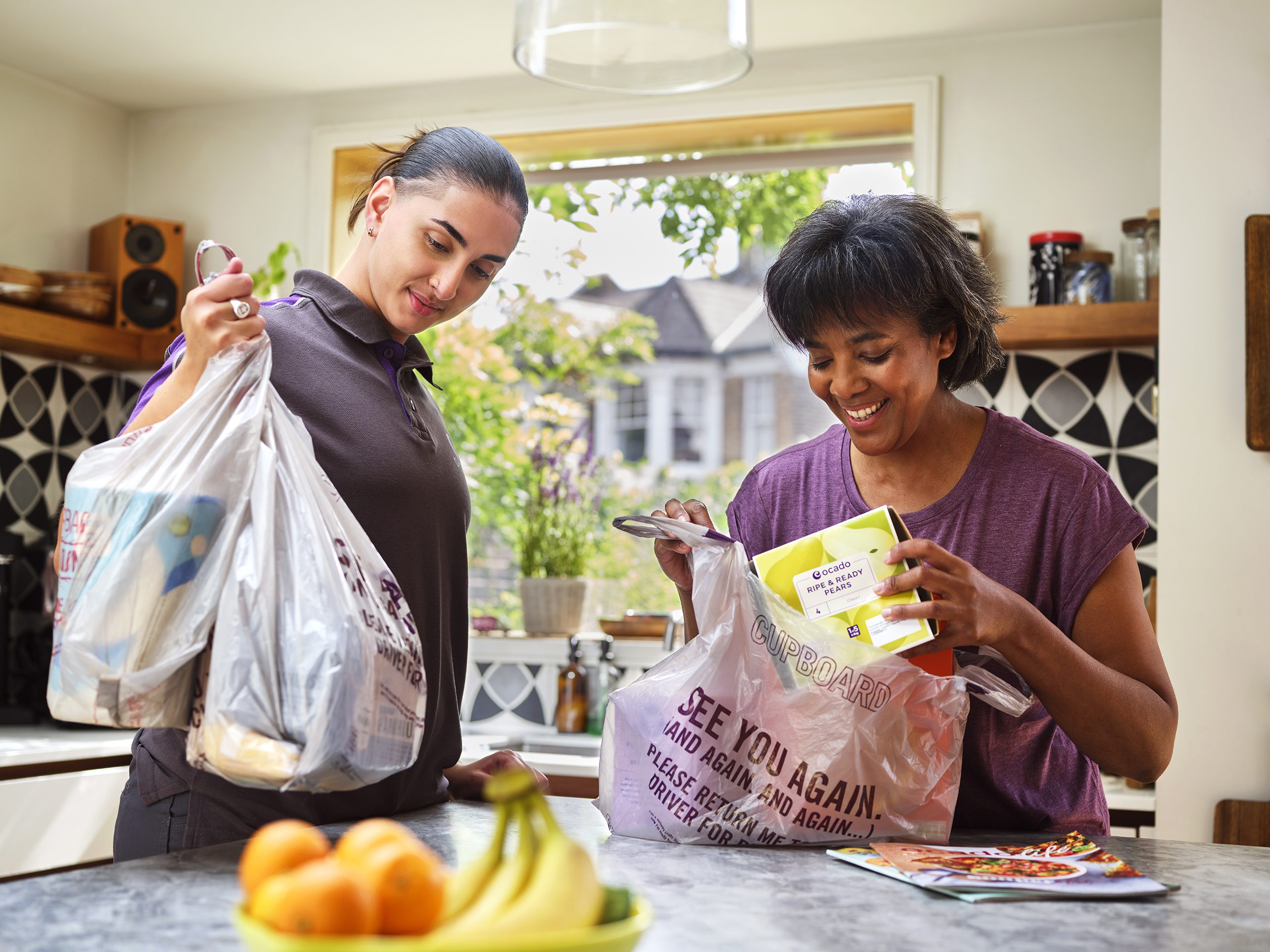 Two people looking at their Ocado shopping