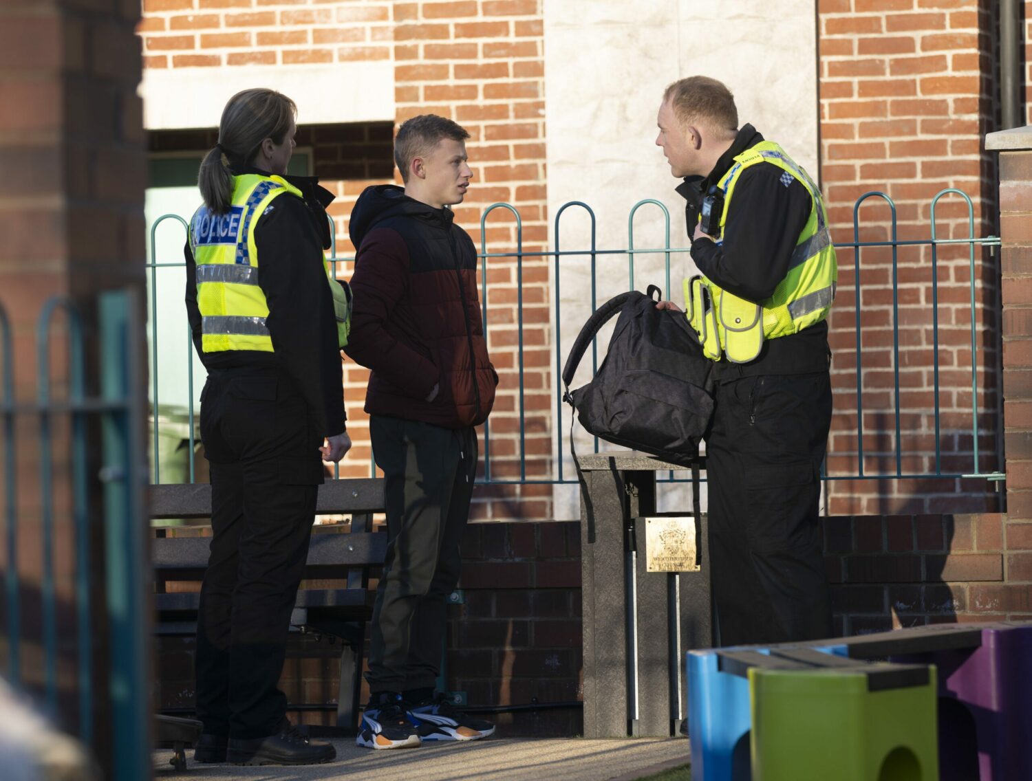 Coronation Street's Dylan is talking to Craig and another police officer as they search through his bag