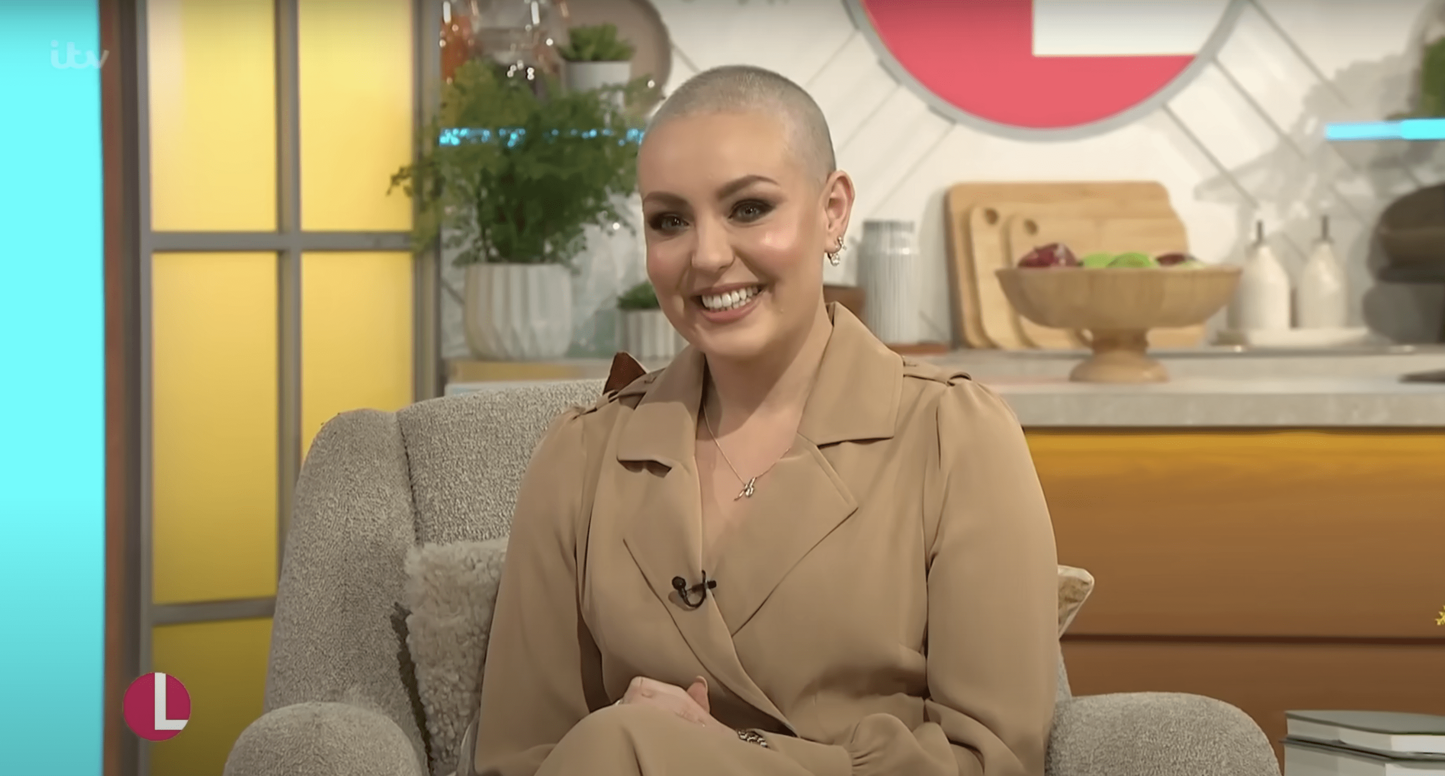 Amy Dowden smiling and wearing a nude suit on whilst sat in the Lorraine studio