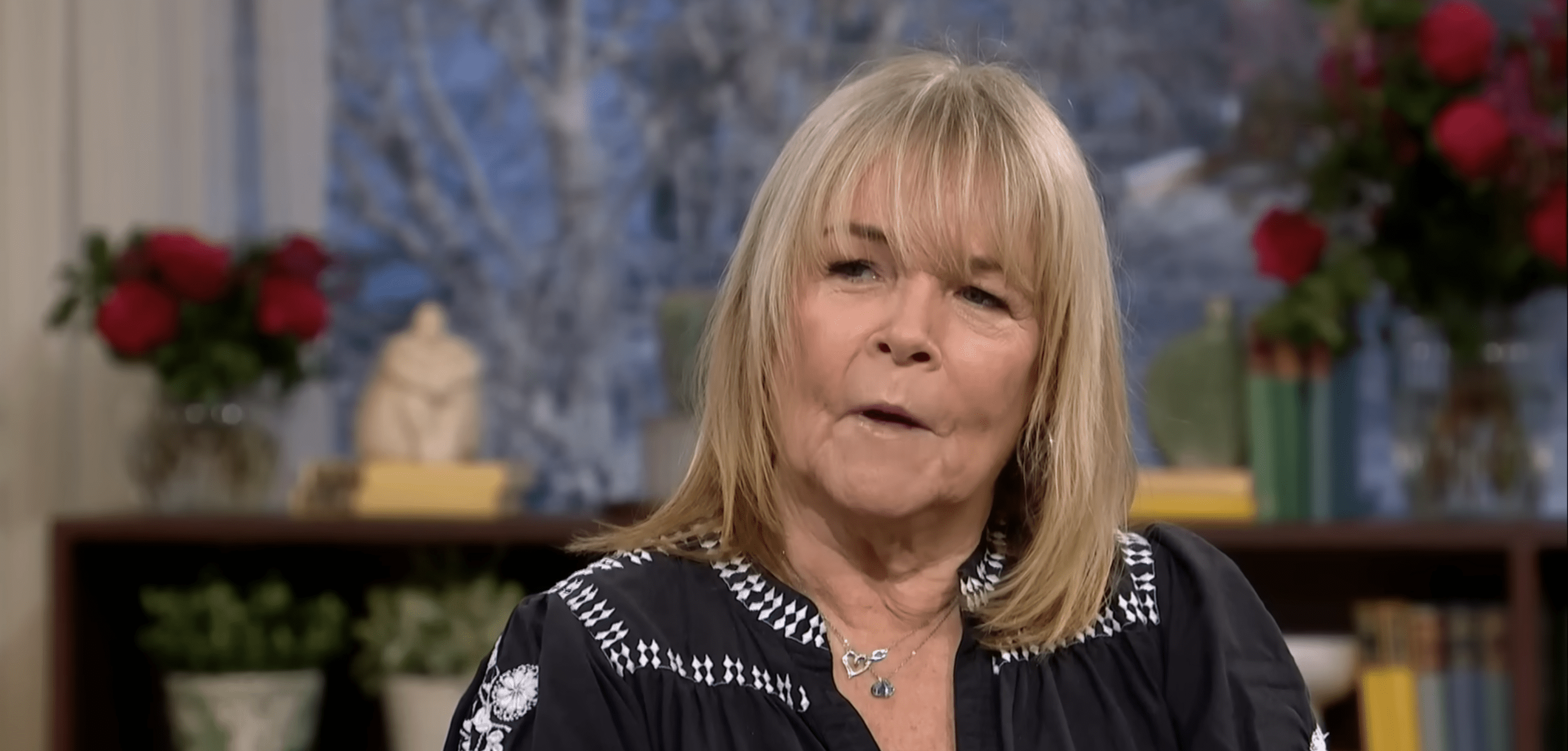 Linda Robson wearing a black top and chatting on This Morning