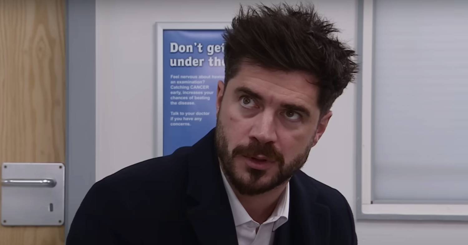 Sam Robertson reacts in character as Adam Barlow on Corrie