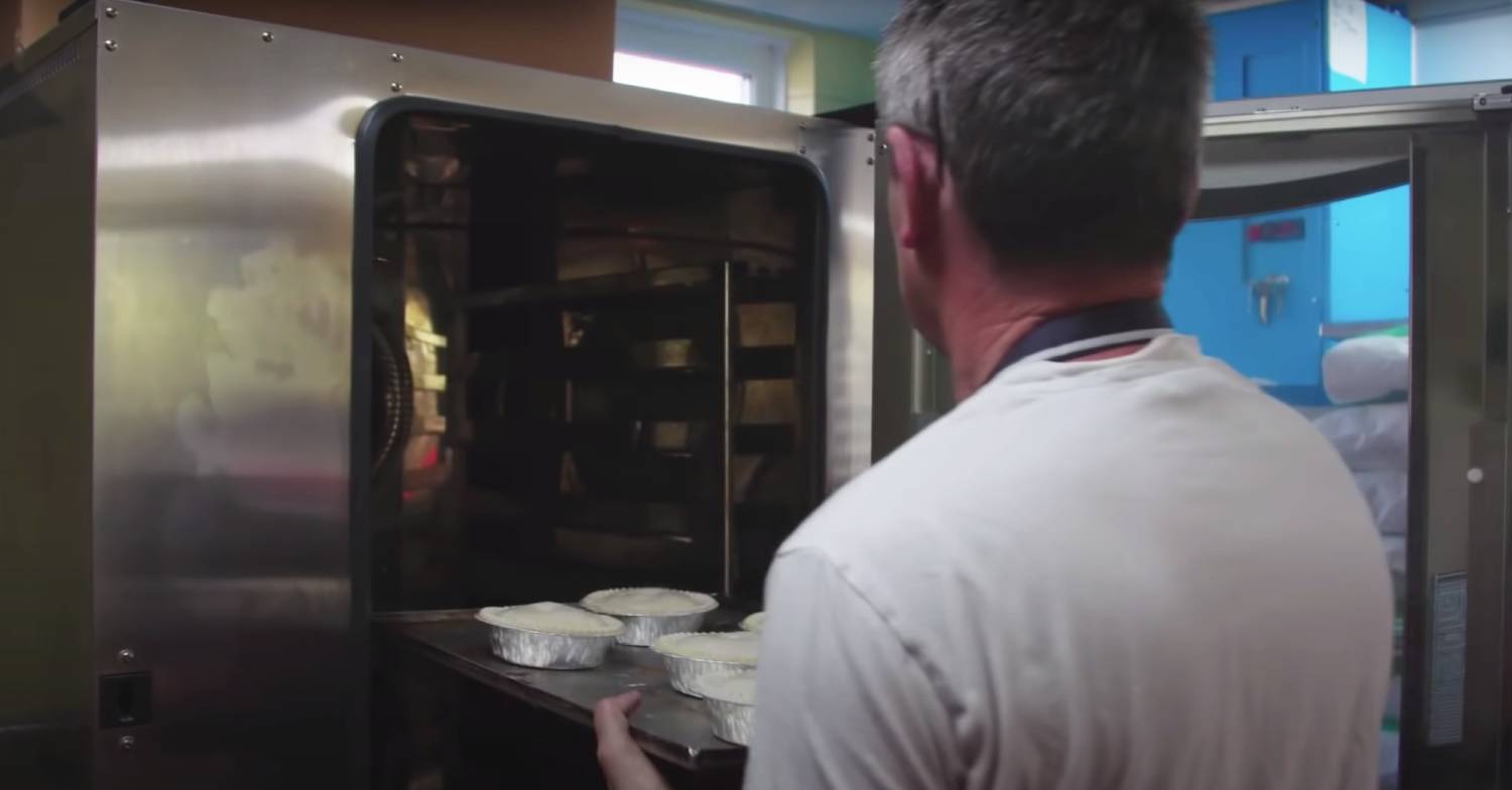 Noel Radford puts pies in the oven