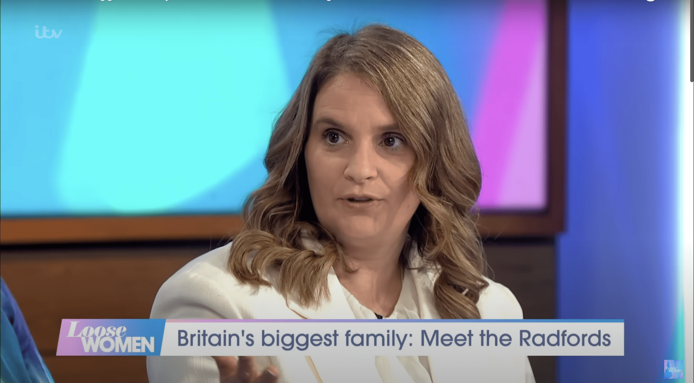 Sue Radford close-up sat at the Loose Women panel table on set