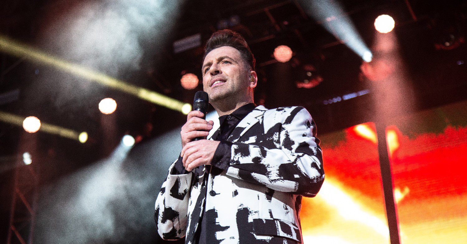 Mark Feehily performing on stage with Westlife