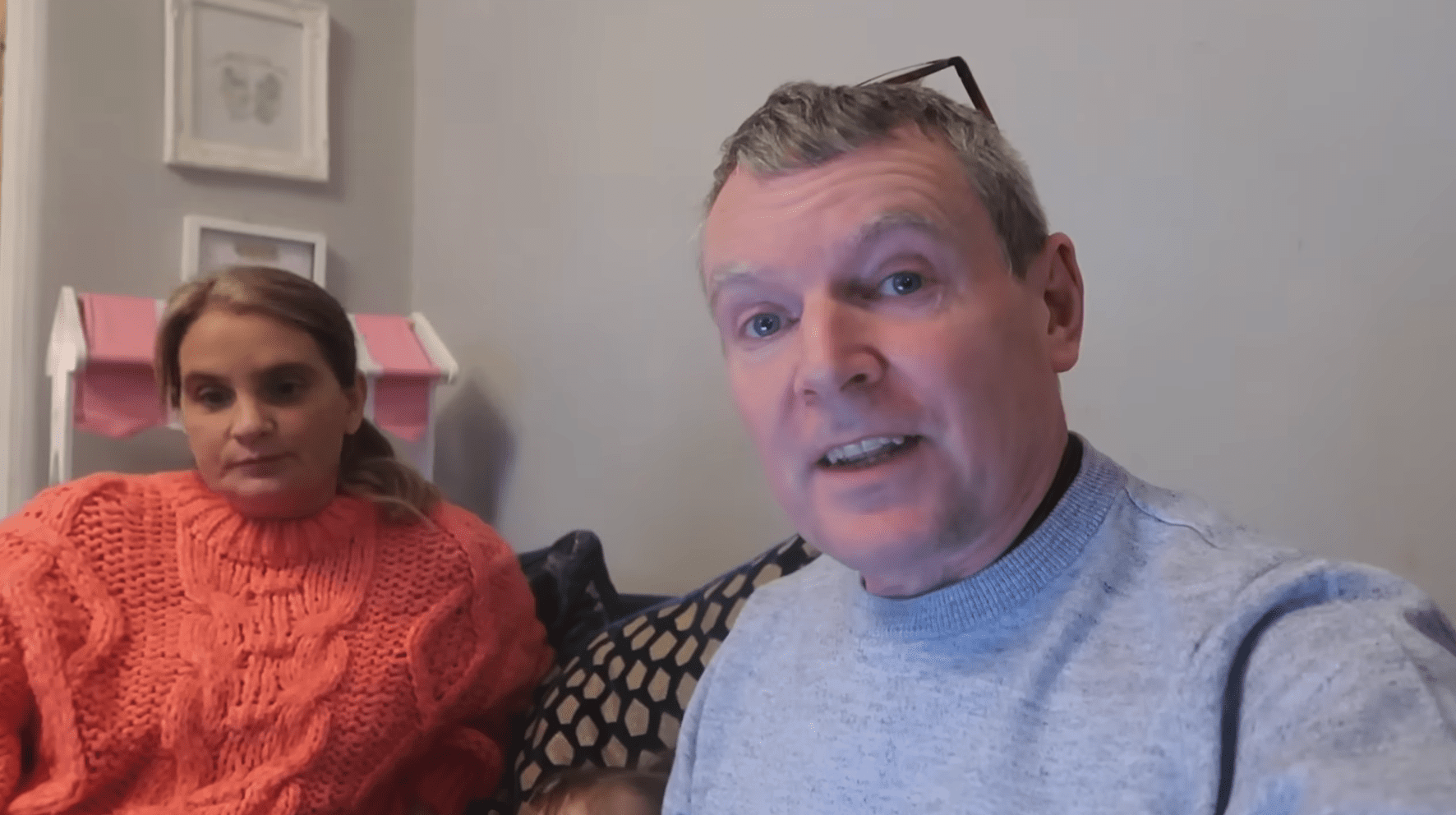 Sue and Noel Radford in their living room speaking to camera