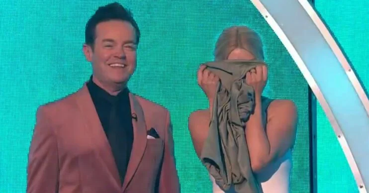 Stephen Mulhern laughing and Holly Willoughby hiding her face