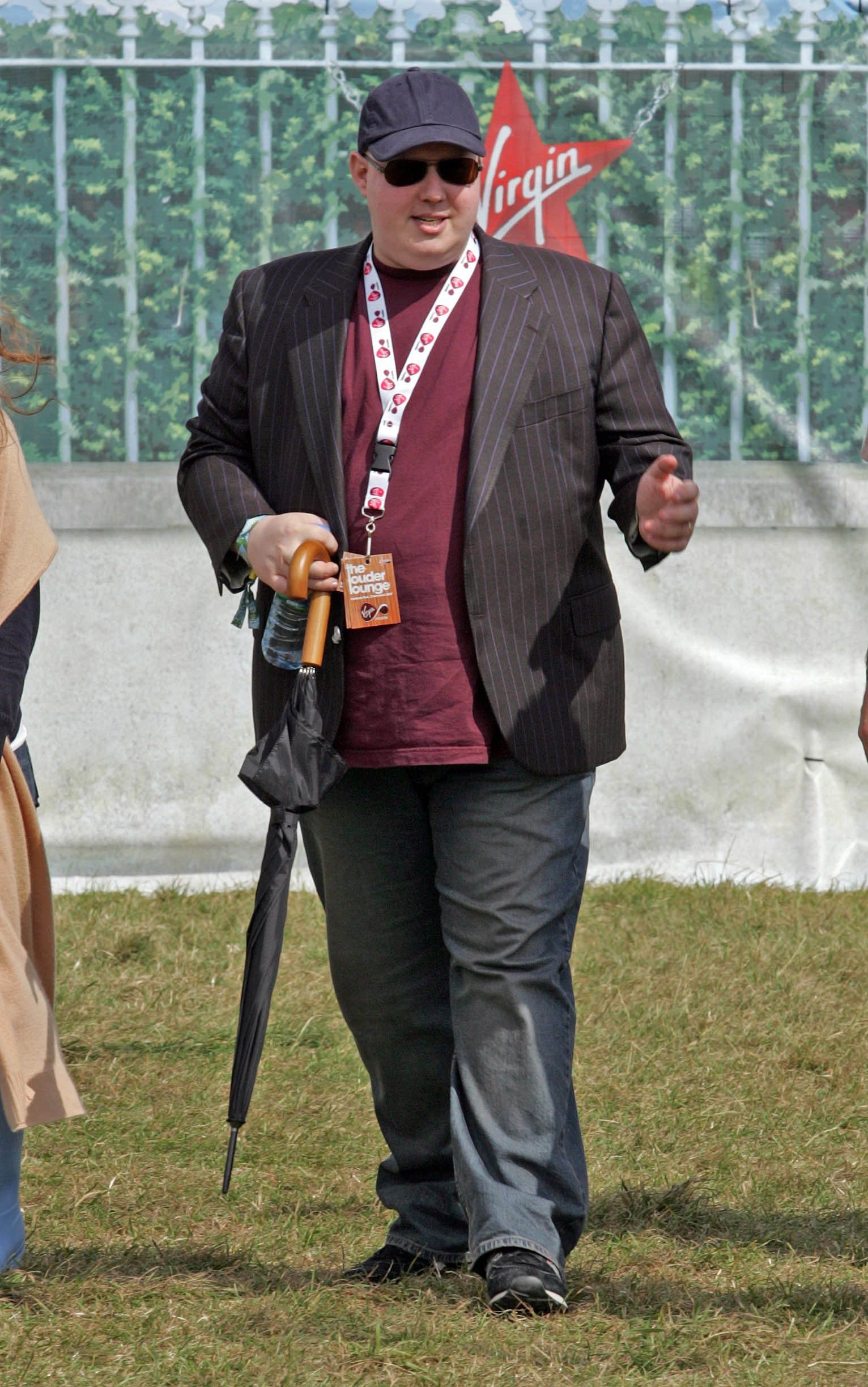 Matt Lucas walking with an umbrella in his hand