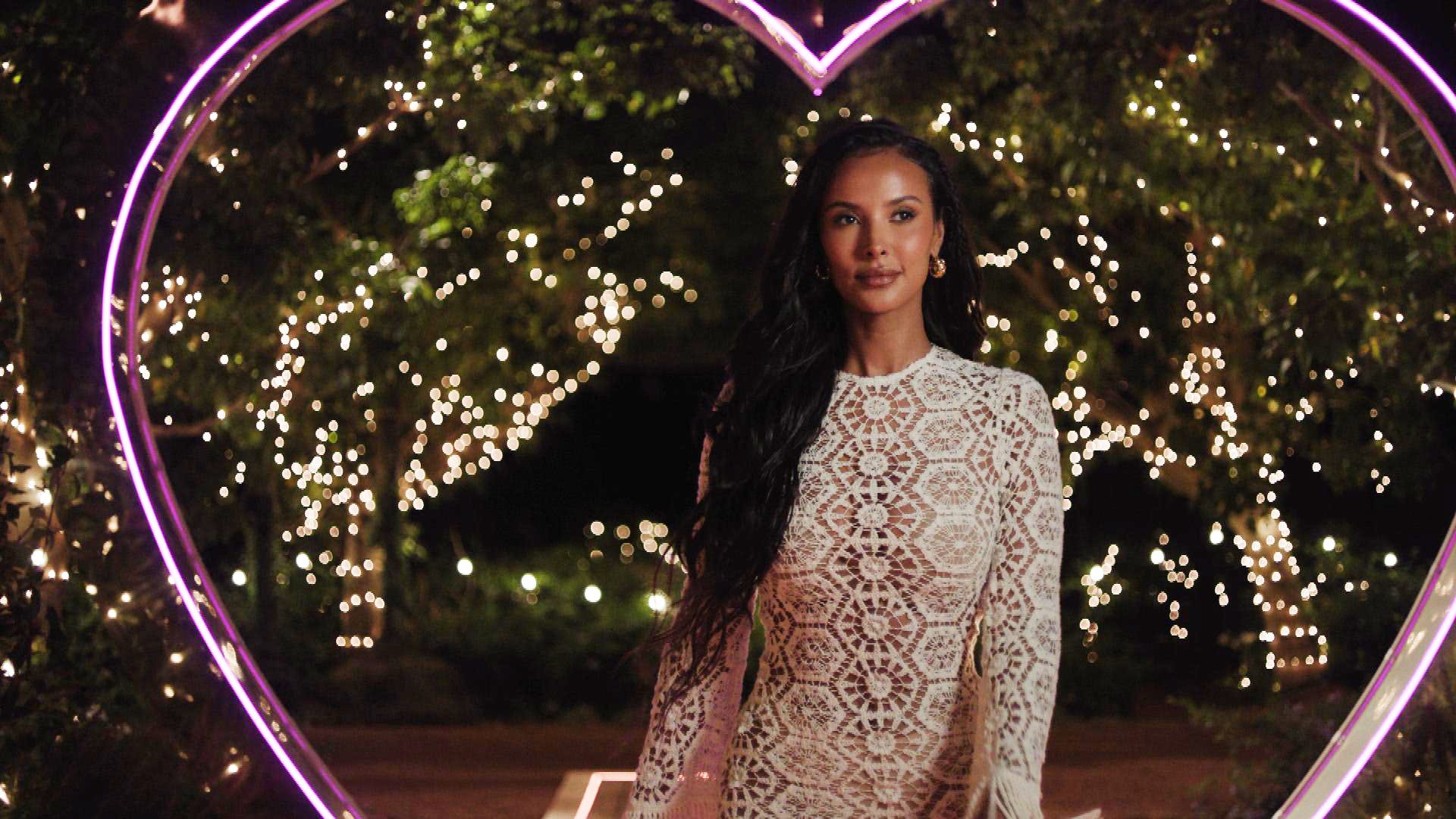 Maya Jama in front of the Love Island pink light-up heart