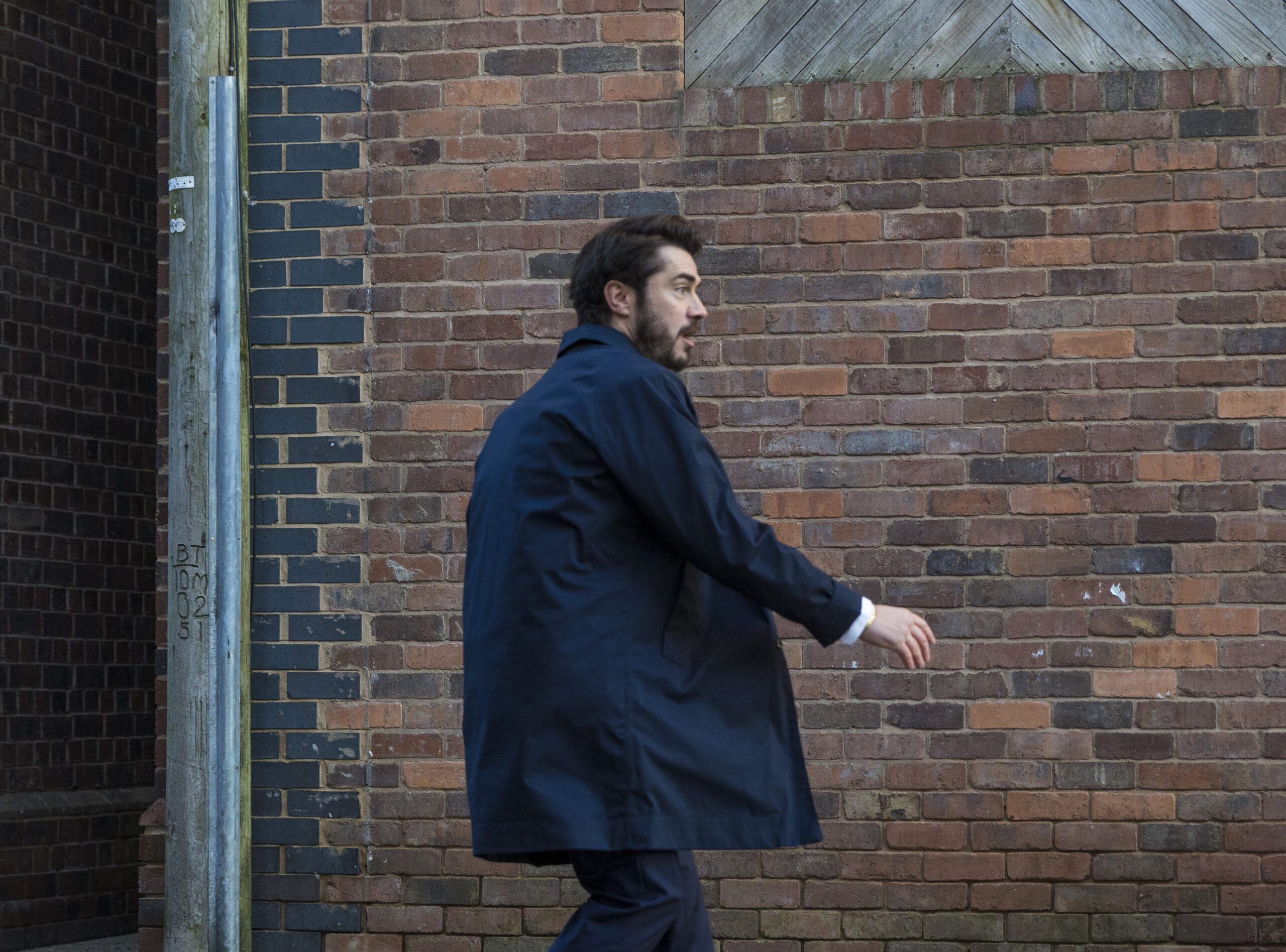 Adam looks on as a car speeds towards him in Corrie