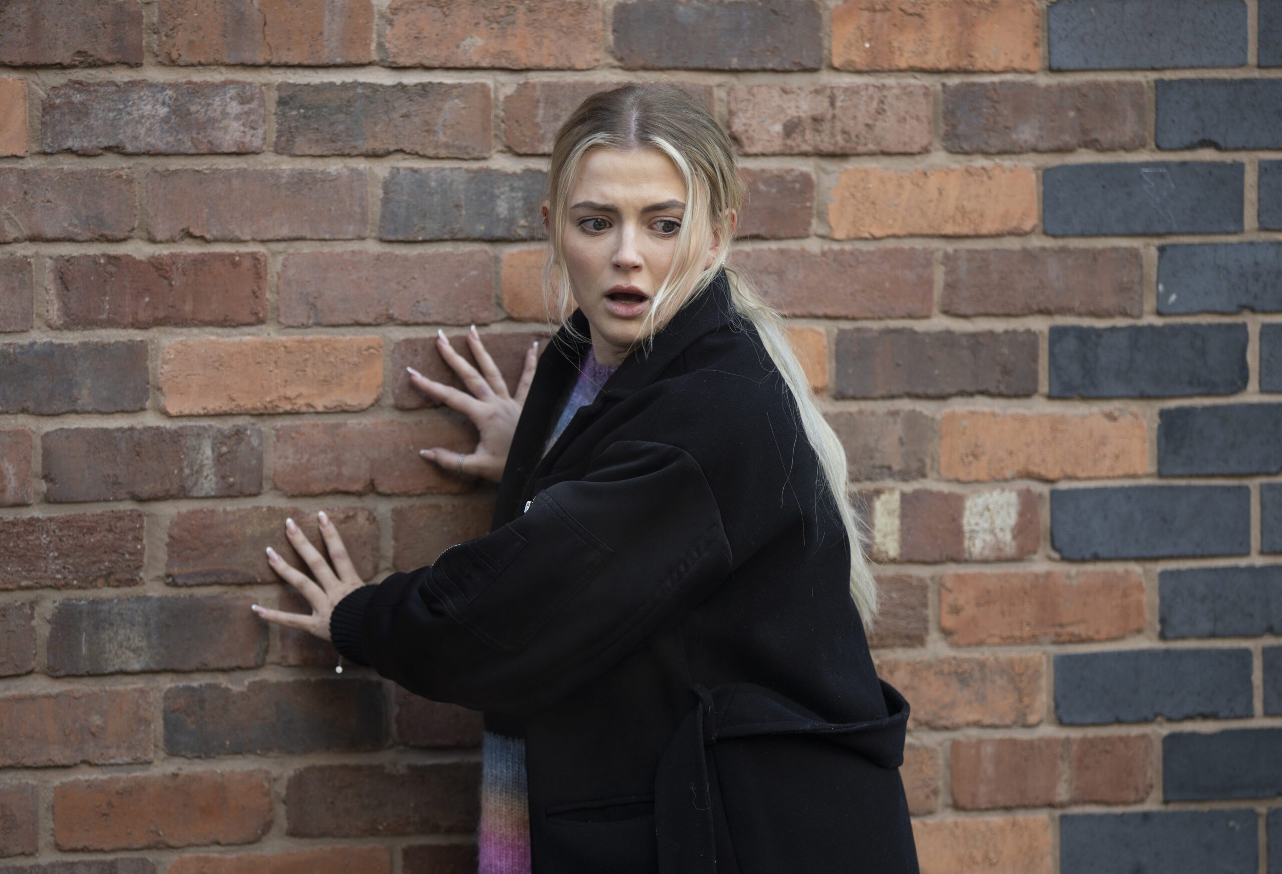 Coronation Street's Bethany is holding onto a wall and is shocked
