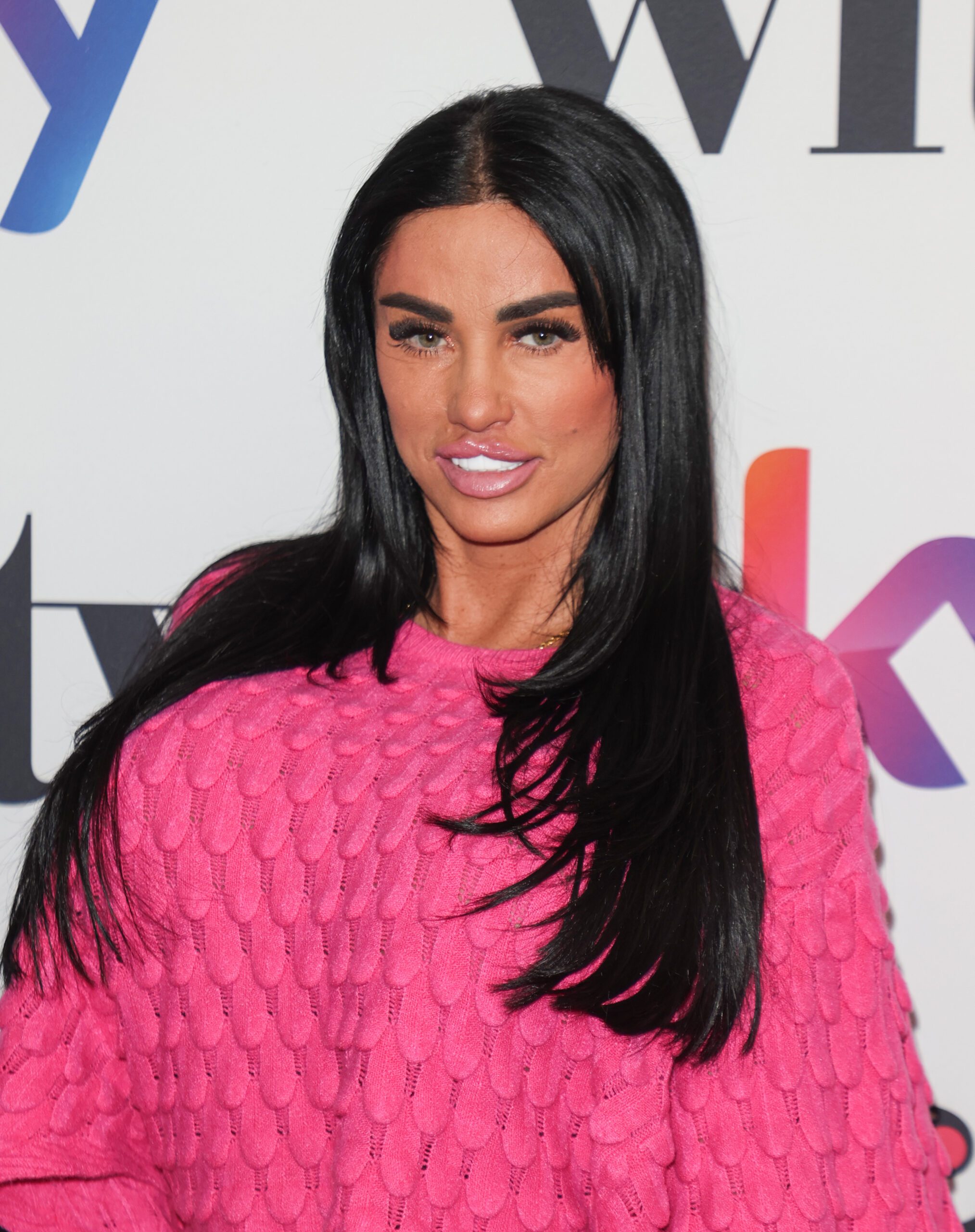 Katie Price wearing a pink jumper and smiling at the Women in film television awards