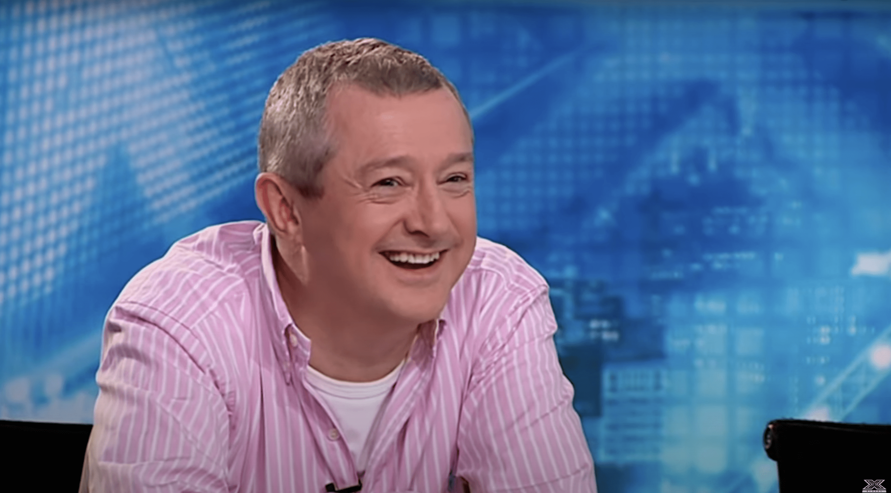 Louis Walsh smiling on set of the x-factor auditions