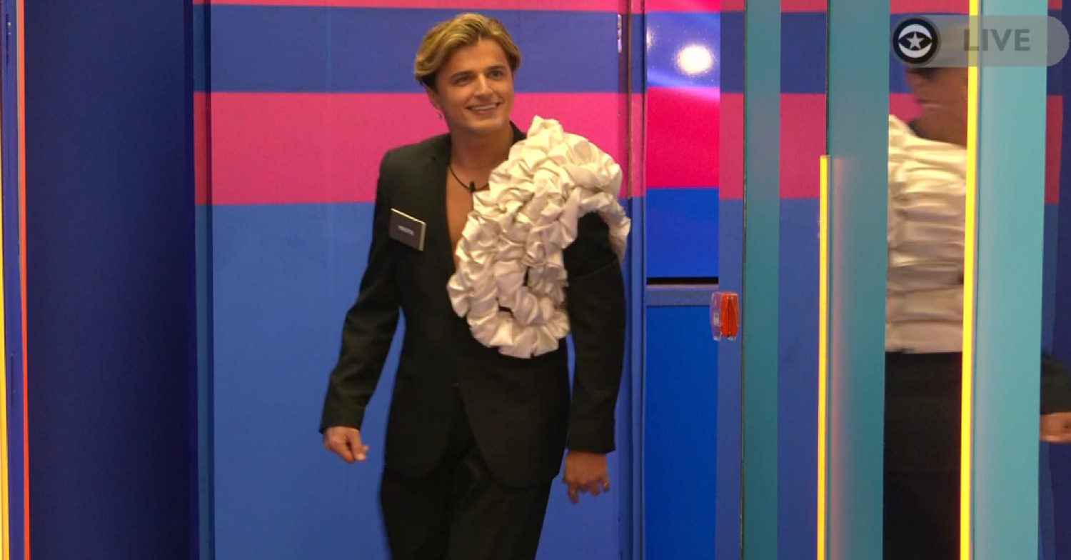 Nikita Kuzmin smiling as he walks into the Celebrity Big Brother house