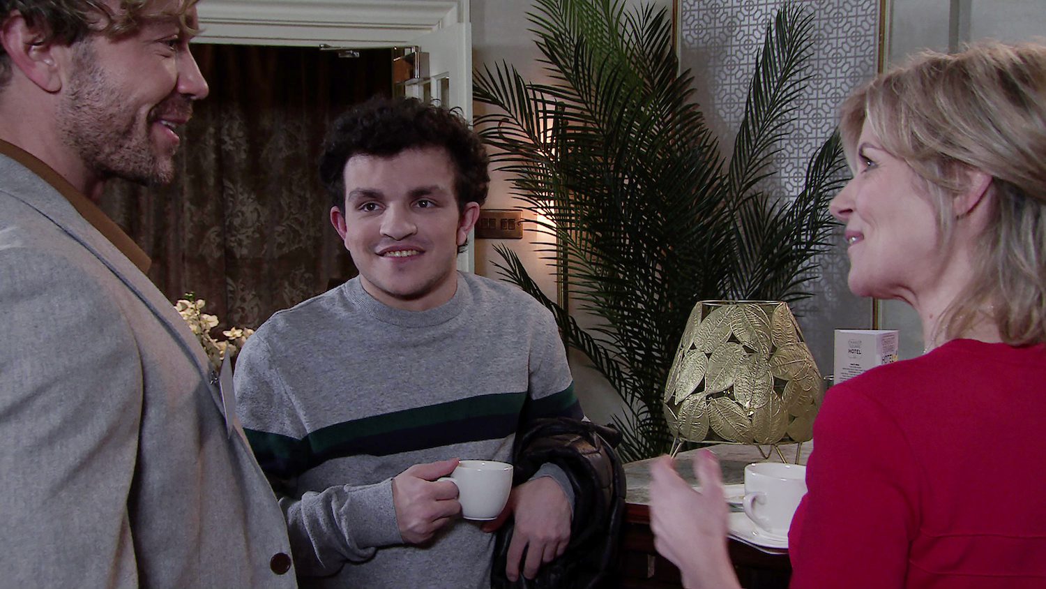 Simon and Leanne smile at Rowan in Corrie
