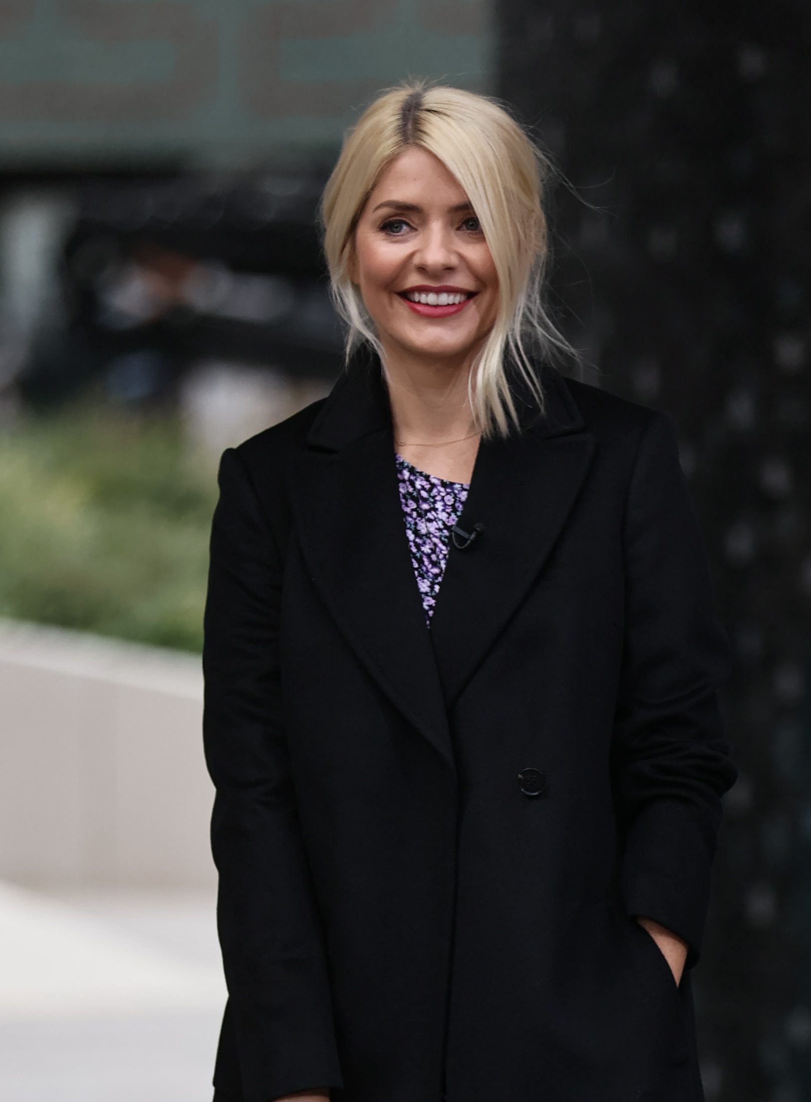 Holly Willoughby wearing a black coat smiling