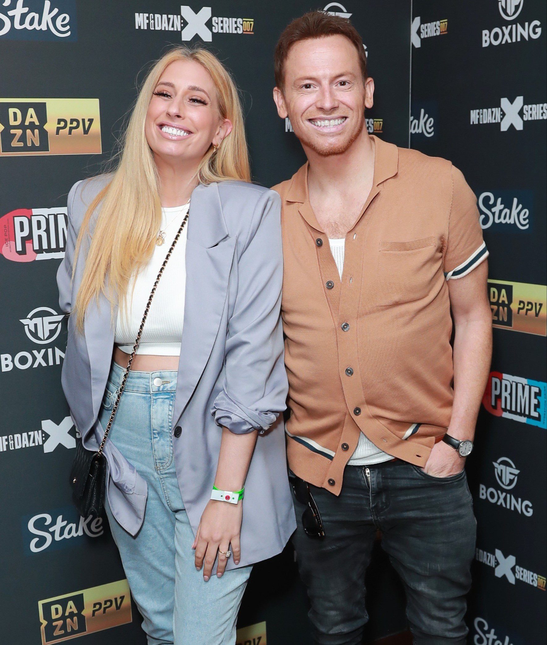 Stacey Solomon and Joe Swash smiling at event