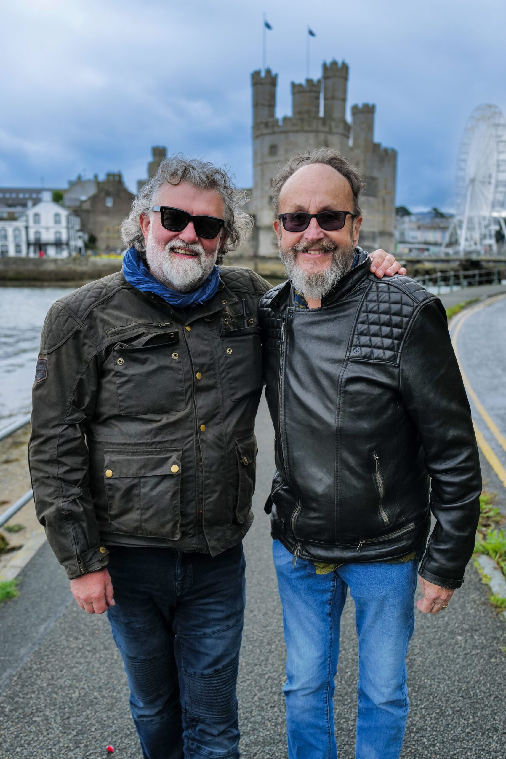 Hairy Bikers Si King and Dave Myers standing in front of a castle