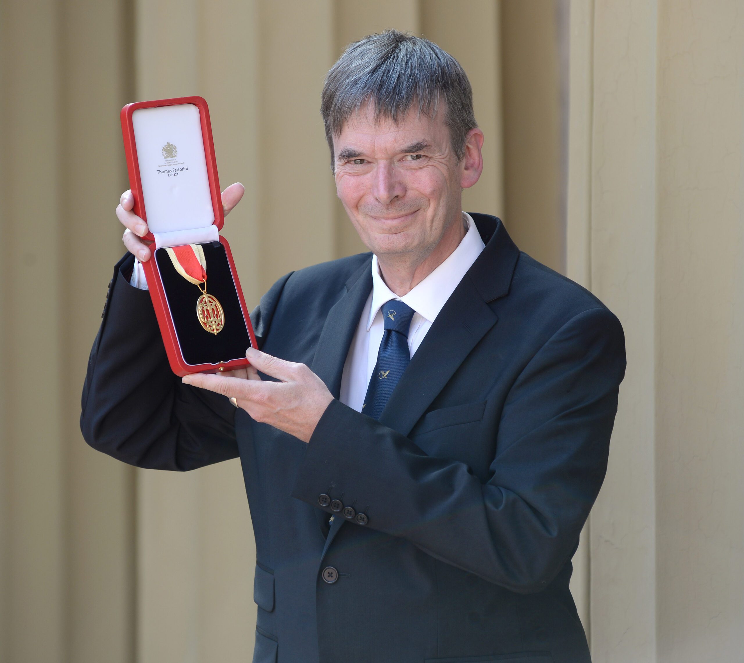 Writer Ian Rankin holding his OBE