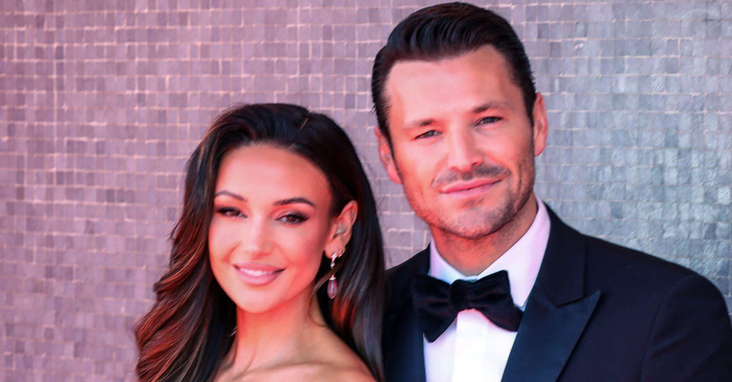 Michelle Keegan and Mark Wright smiling on a red carpet