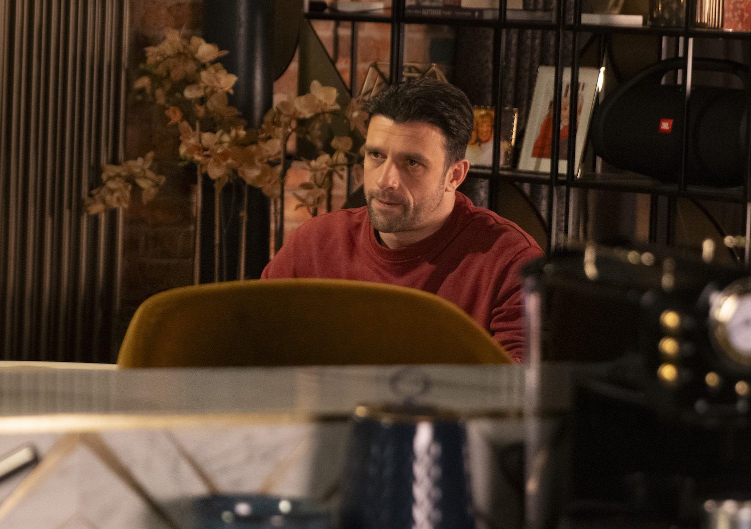 Coronation Street's Damon is sitting whilst looking serious