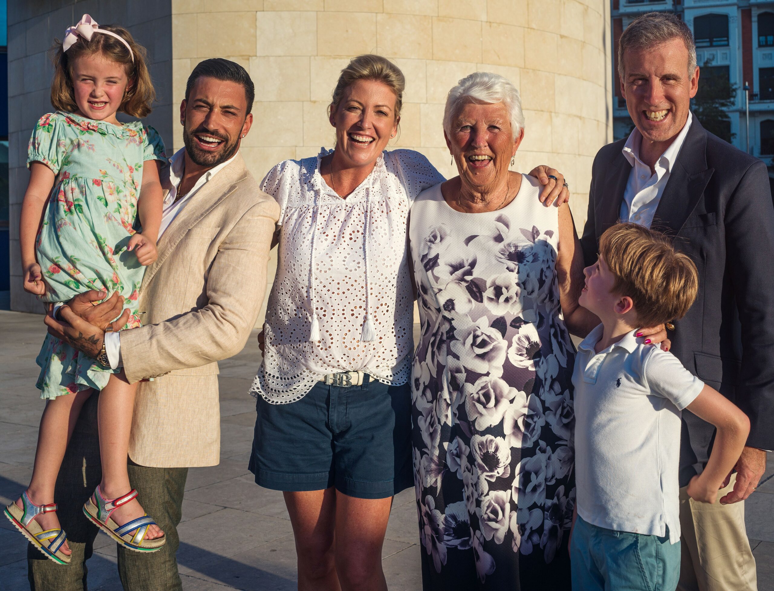 Giovanni Pernice smiling with Anton Du Beke and his family in Spain travel show