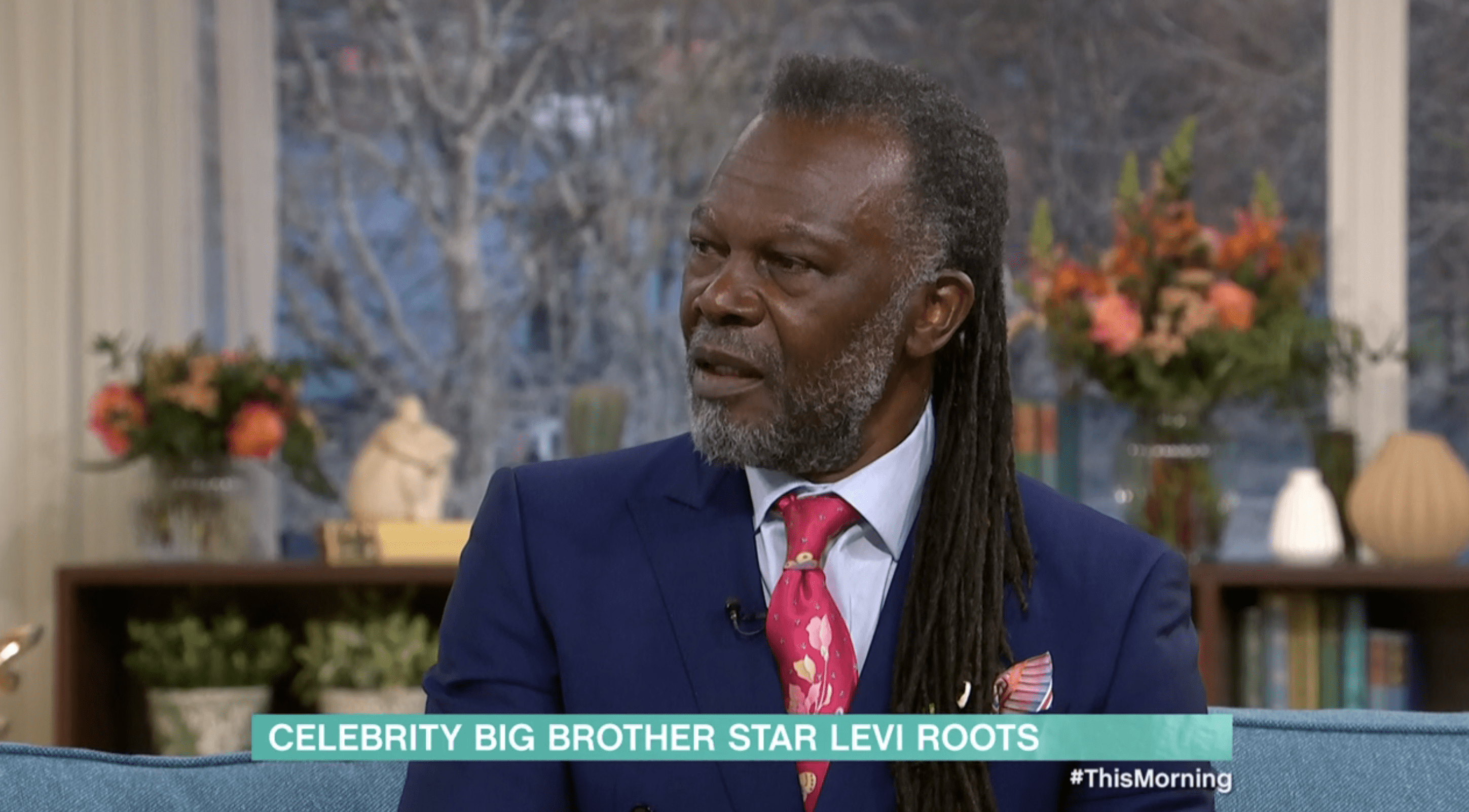 Levi Roots on This Morning wearing a navy suit