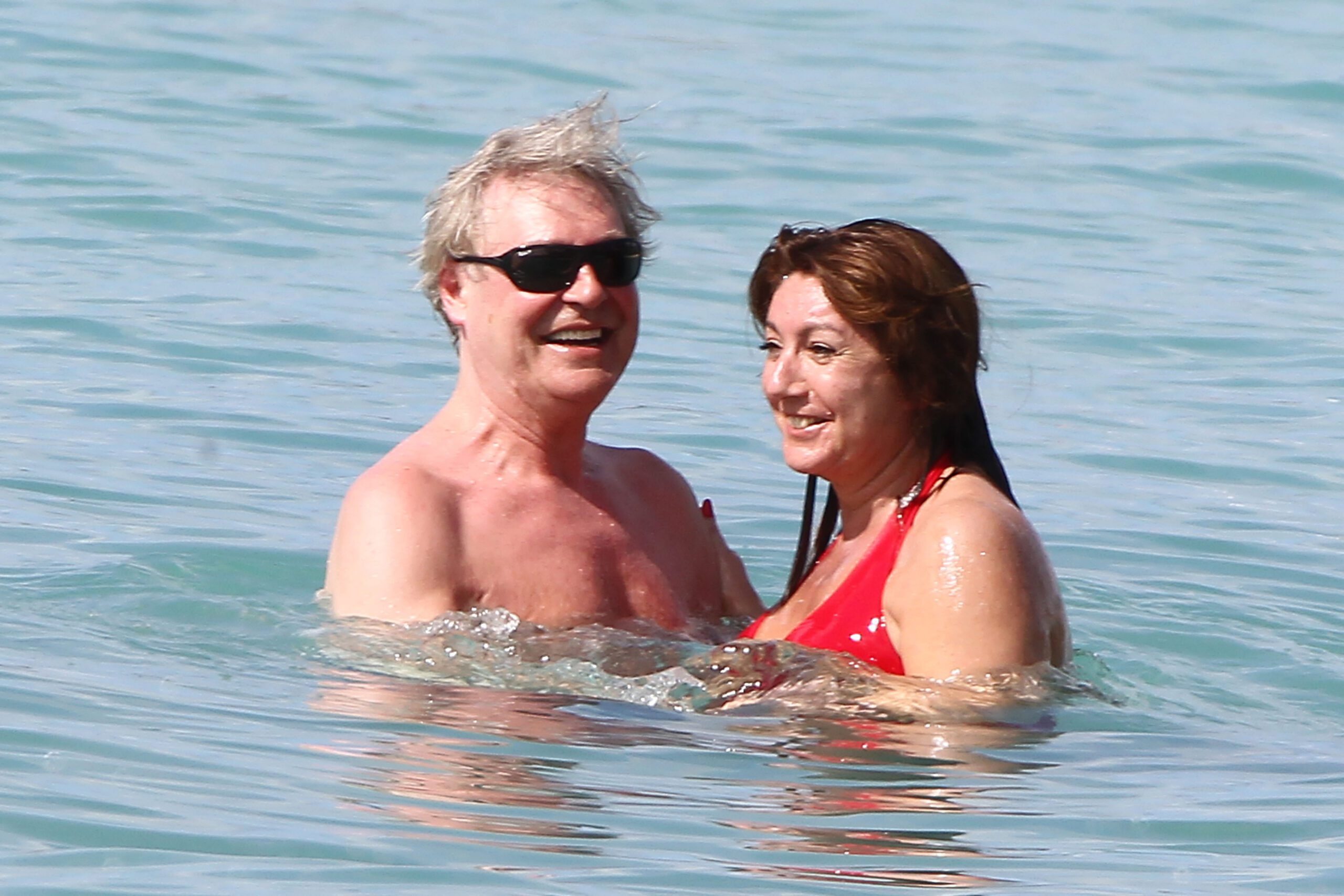 Jane McDonald and her fiancé Ed Rothe in the sea on holiday