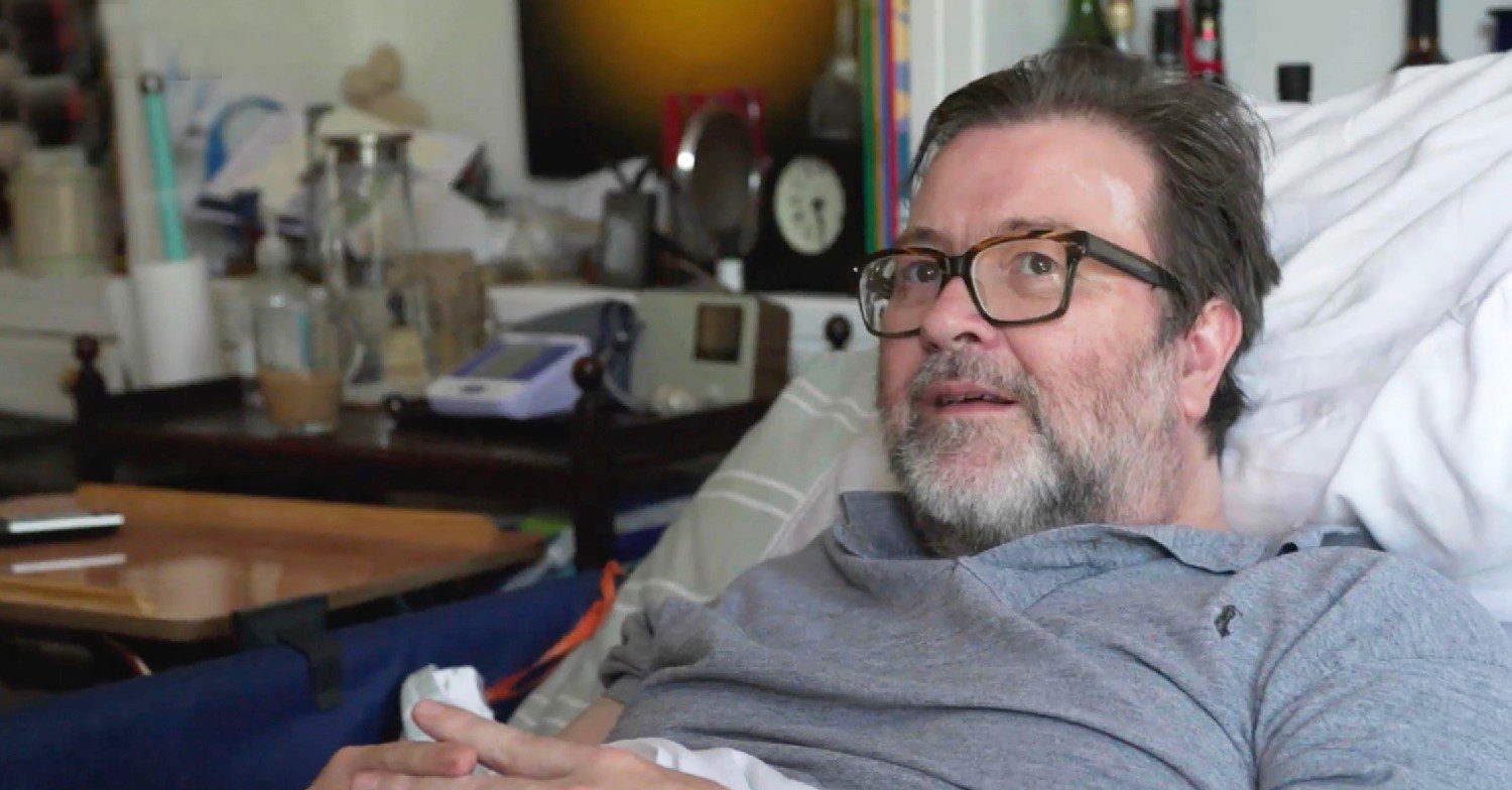 Derek Draper smiling in bed