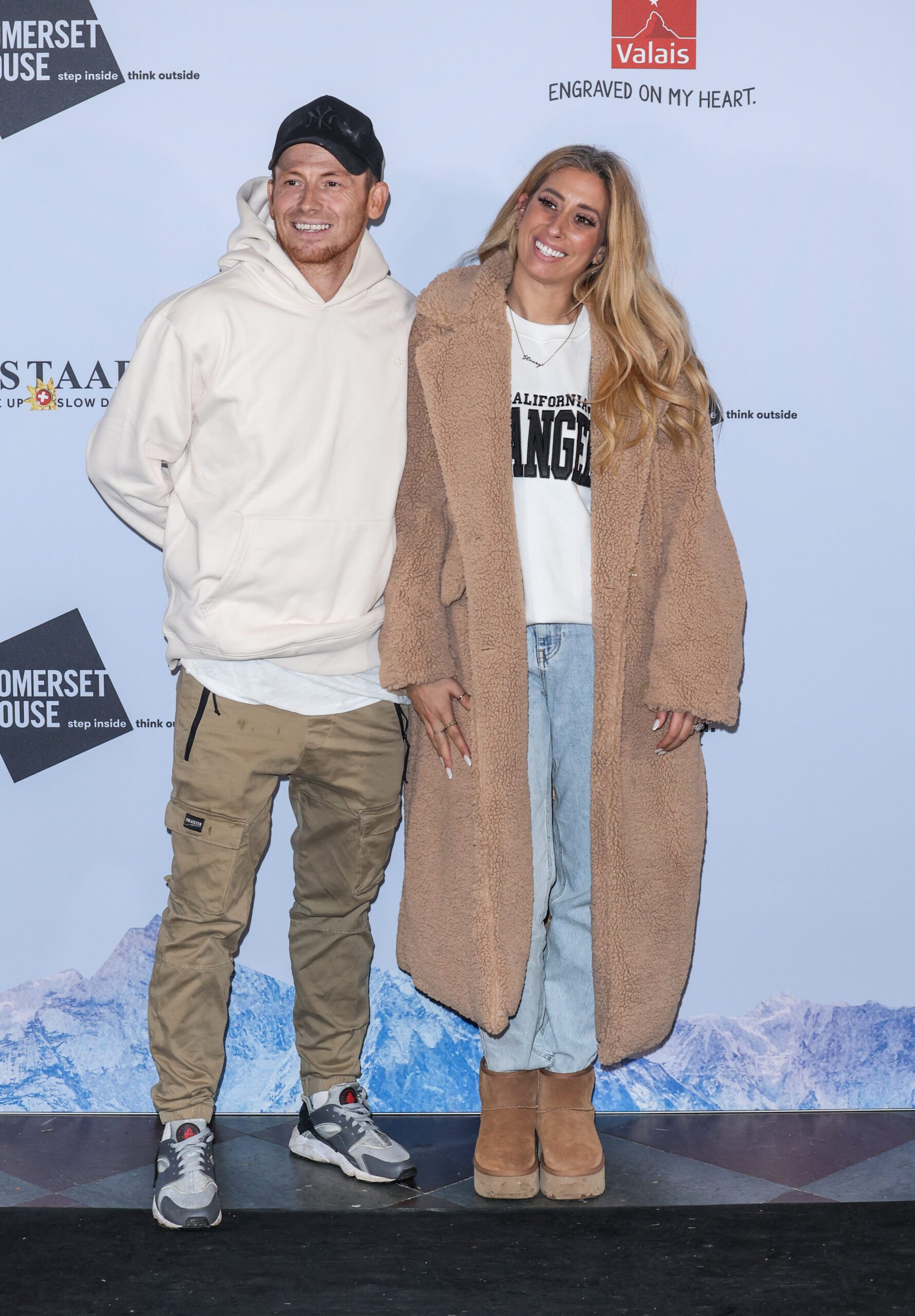 Stacey Solomon and Joe Swash posing for an event