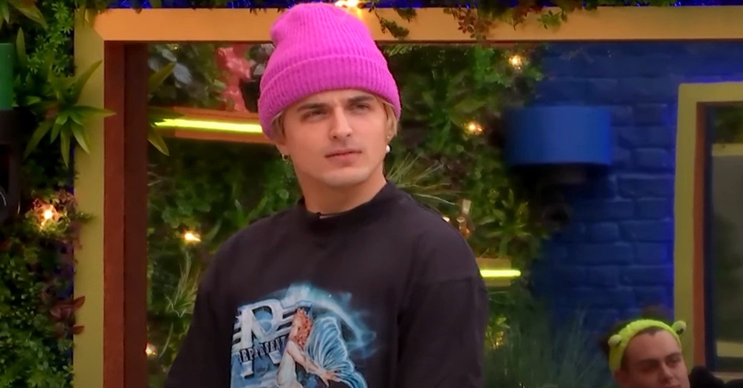 Nikita Kuzmin looking confused in a pink hat on Celebrity Big Brother