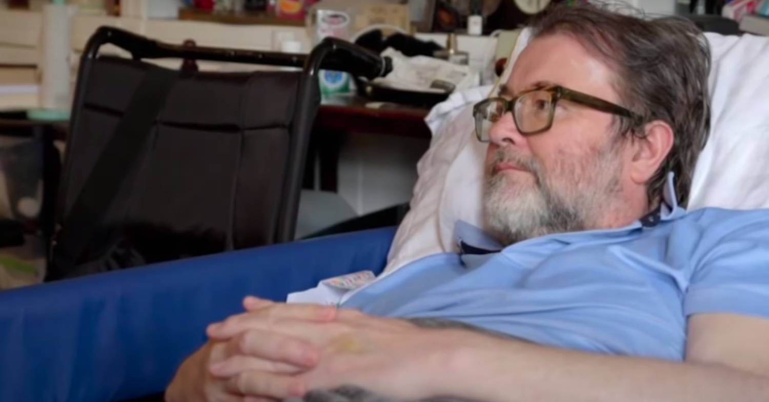 Derek Draper listens to his wife as she speaks