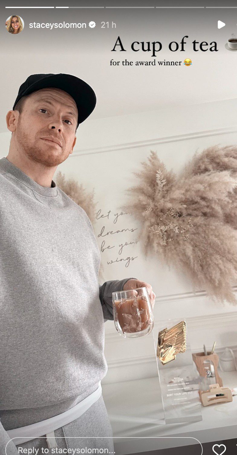 Joe Swash frowning whilst holding a cup of tea
