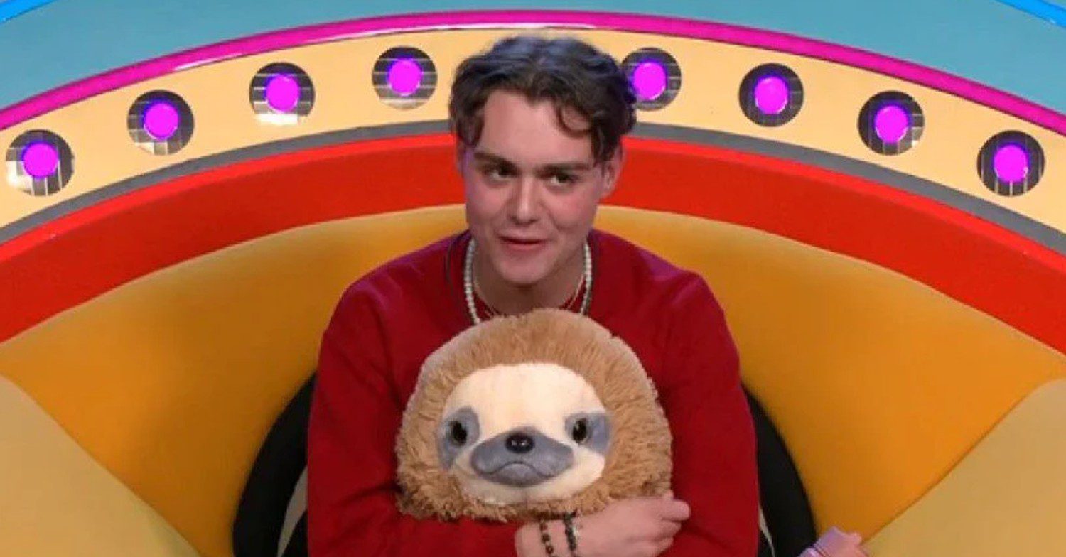 Bradley Riches sat in the diary room holding a toy sloth