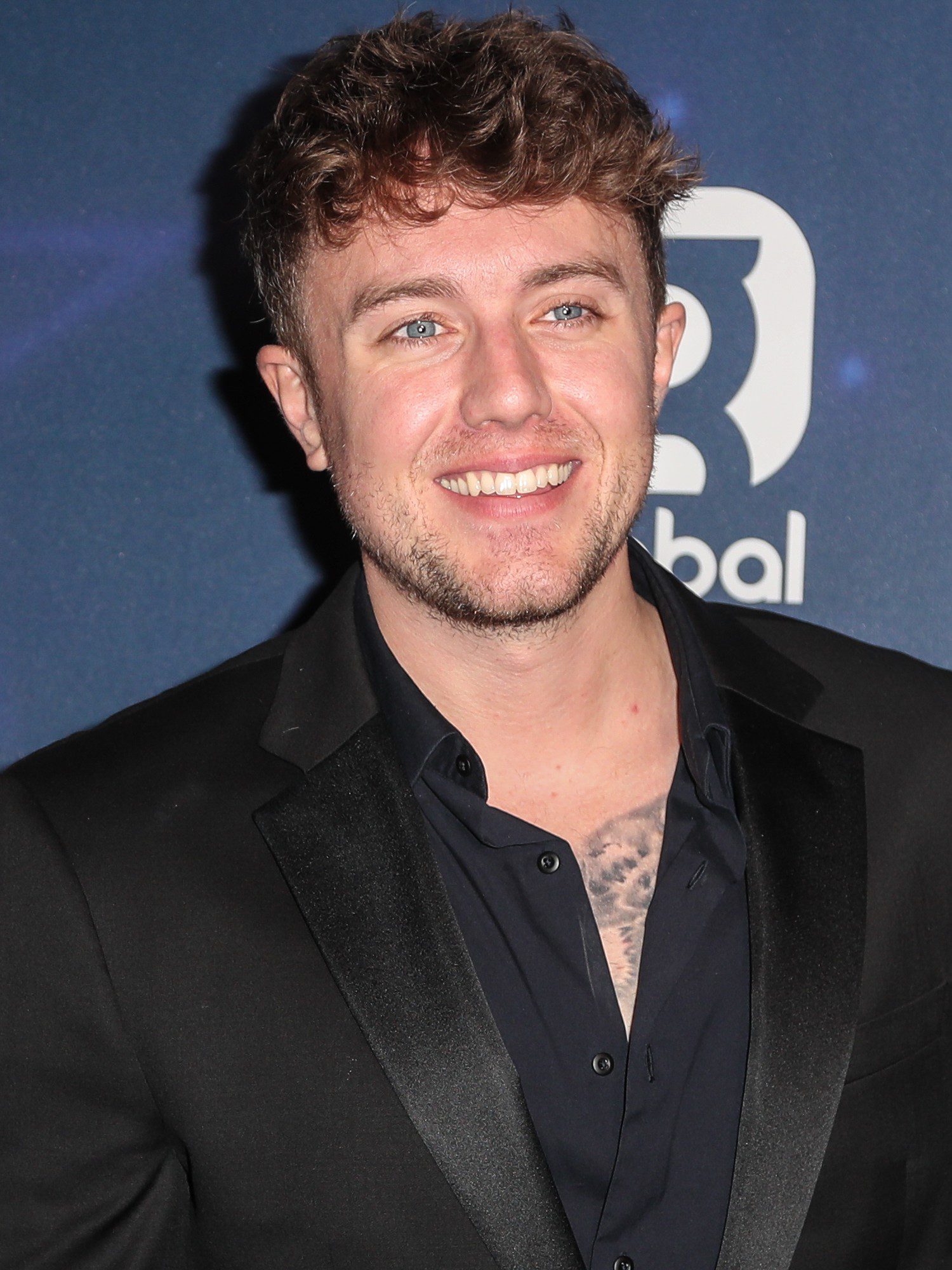 Roman Kemp smiling at Global Radio event