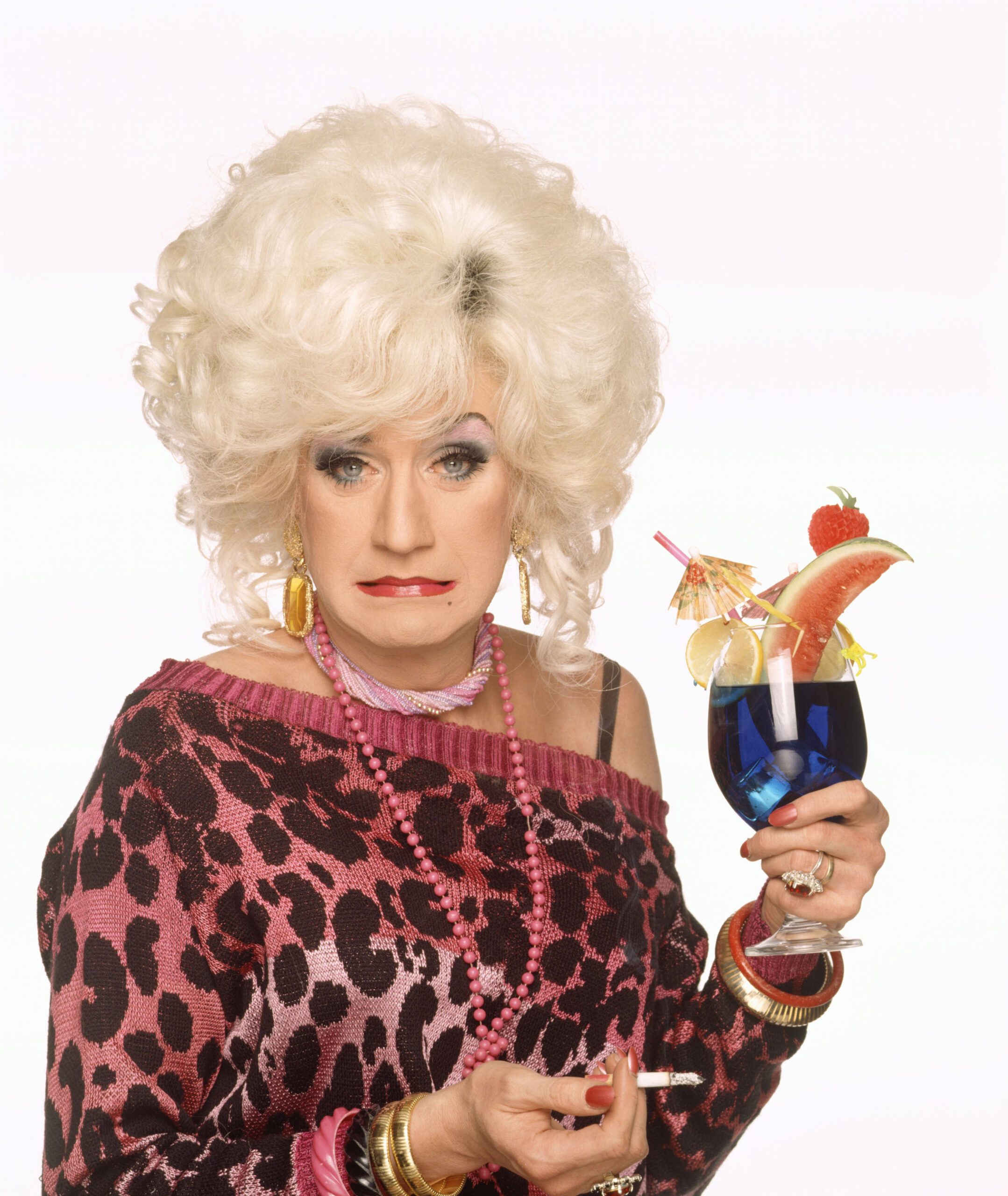 Lily Savage holding a cocktail