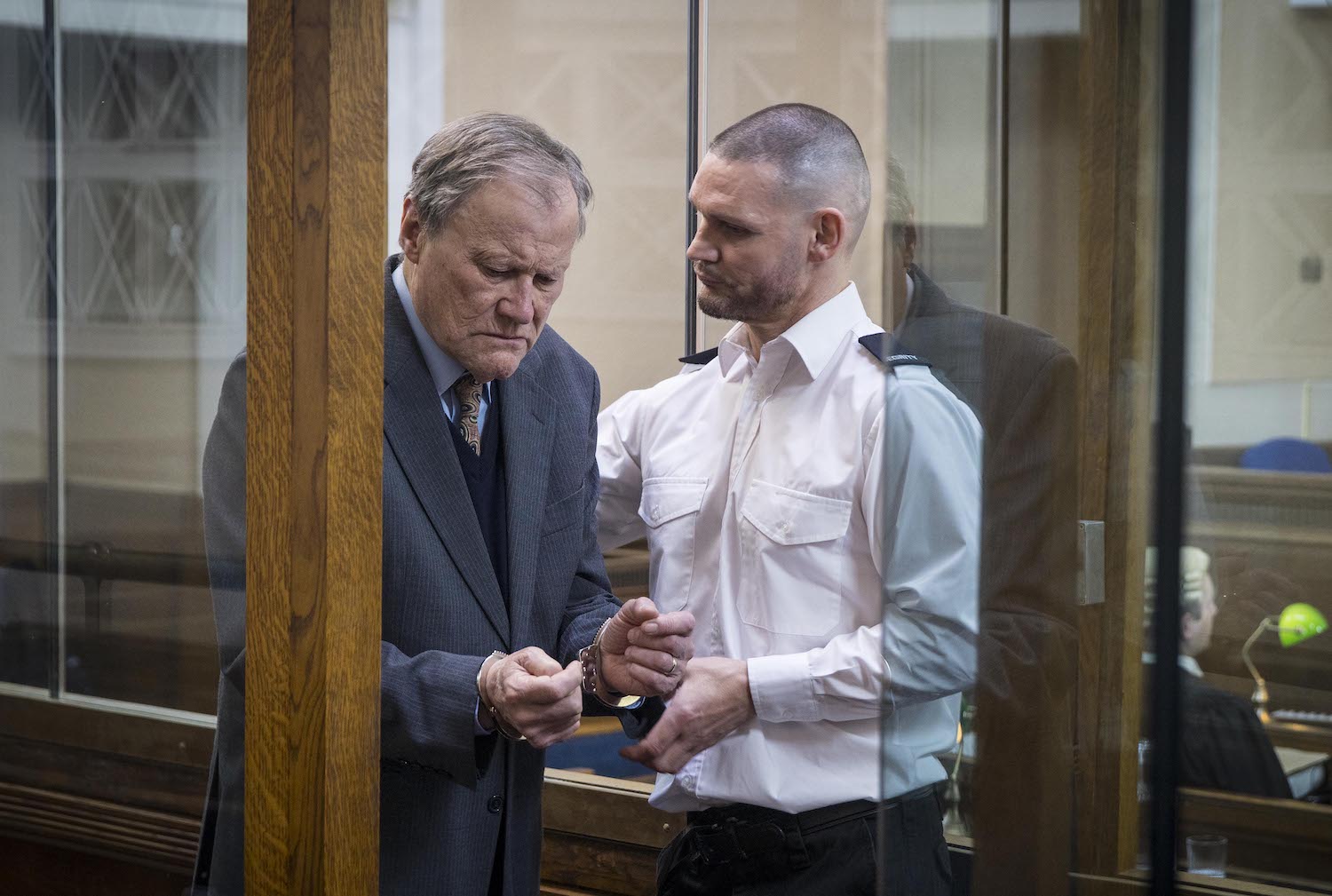 Handcuffed Roy Cropper is lead away by the guard in Corrie