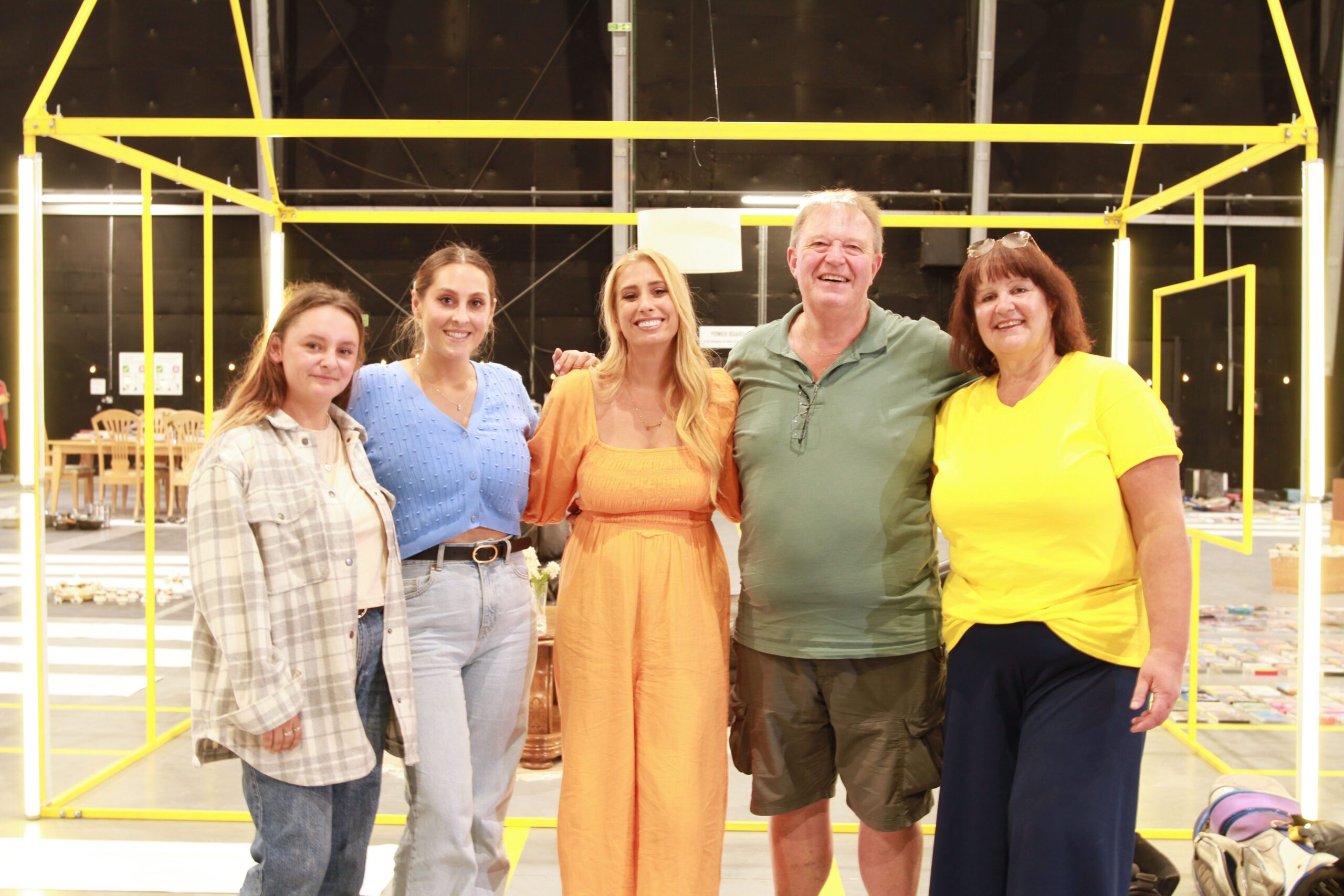 Stacey Solomon in orange dress stood with the wellen family on Sort Your Life Out