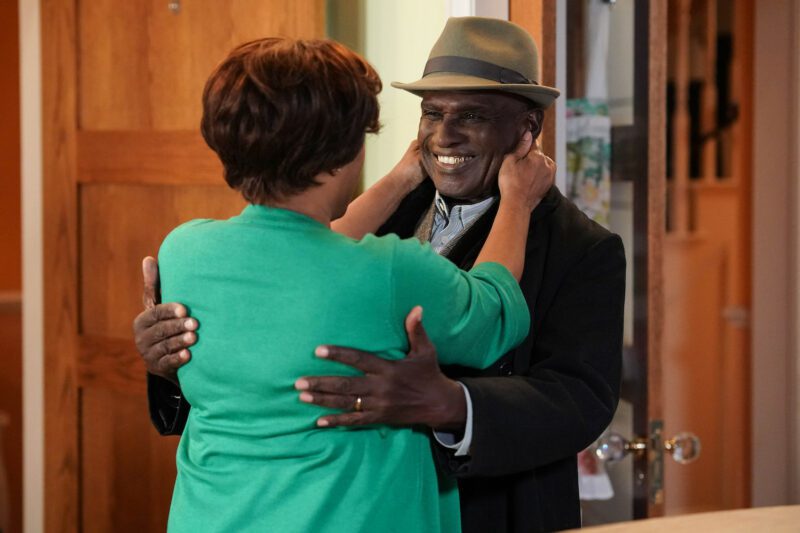 Patrick and Yolande smiling at each other