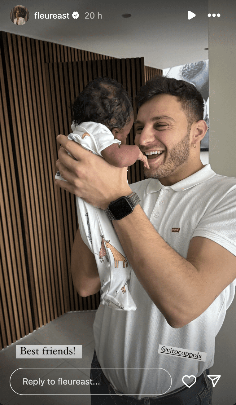 Vito Coppola holding up Fleur East's baby and smiling 