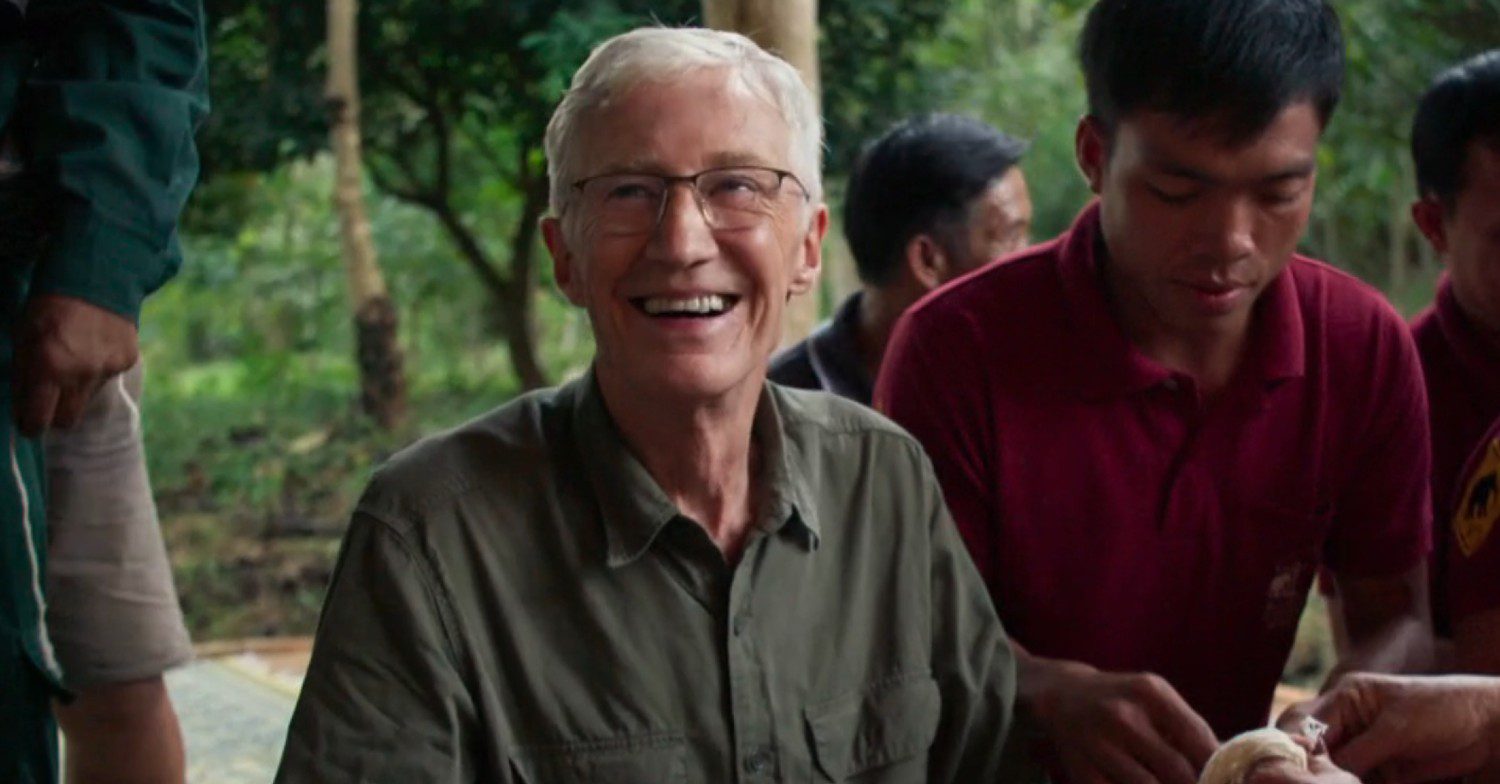 Paul O'Grady smiling whilst at a spiritual ceremony in Thailand