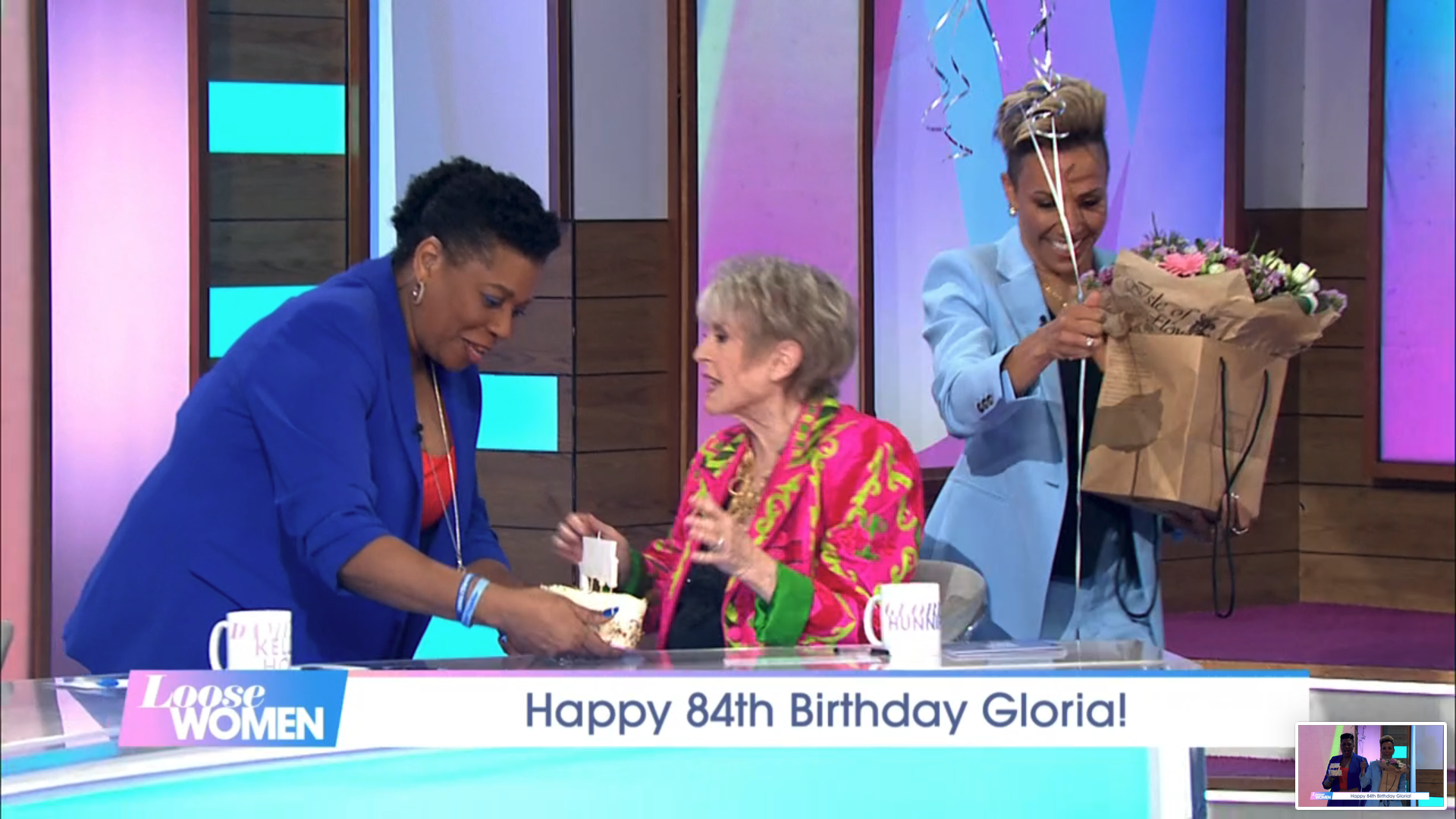 Brenda Edwards hands Gloria Hunniford a birthday cake