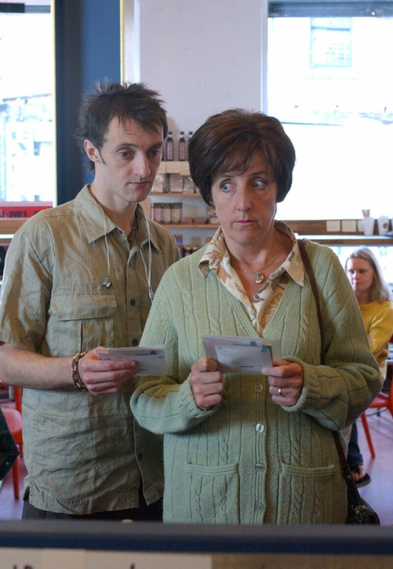 Hayley Cropper looks nervous as she holds a CD and Christian comes up behind her
