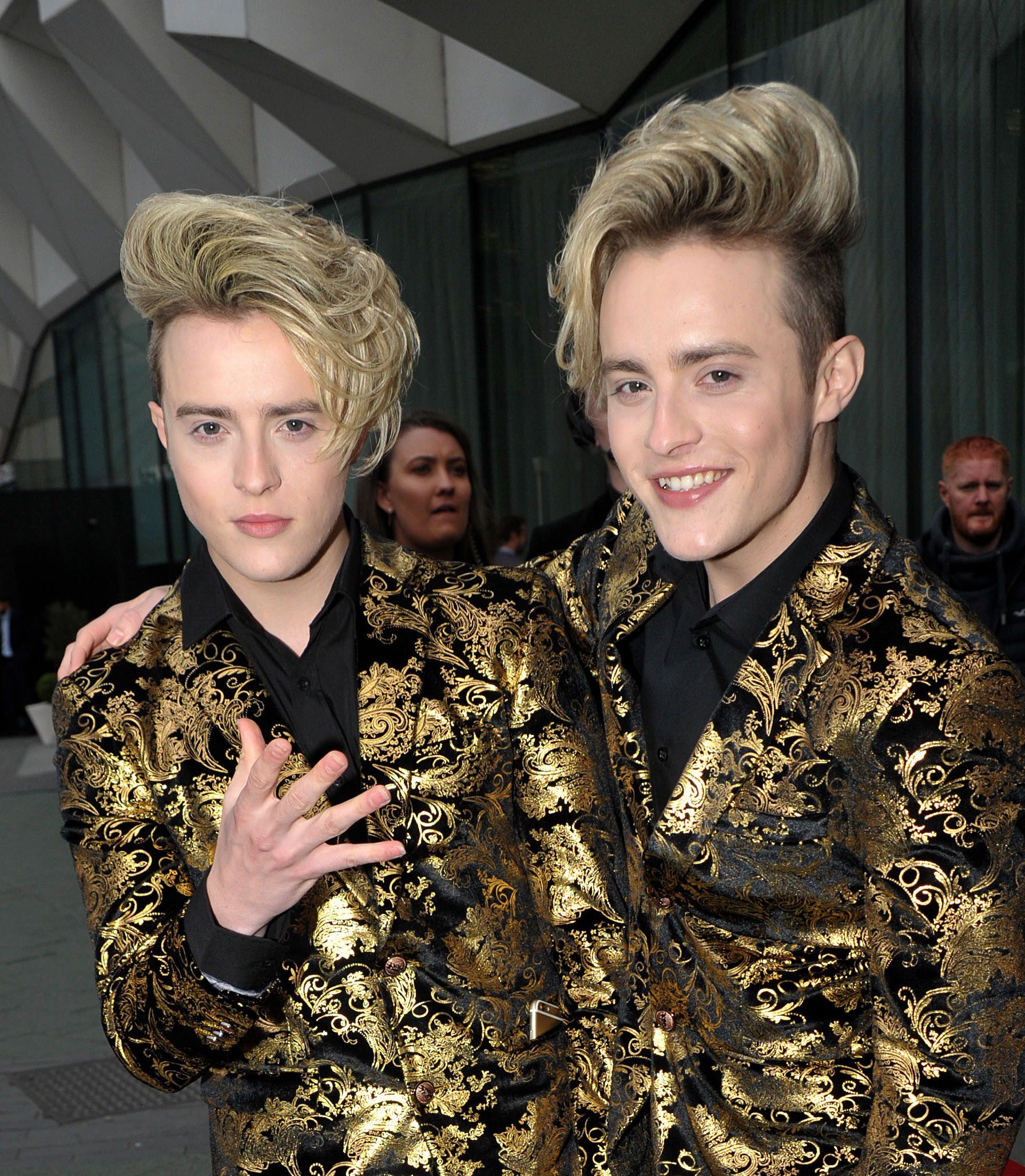 Jedward posing in matching gold outfits