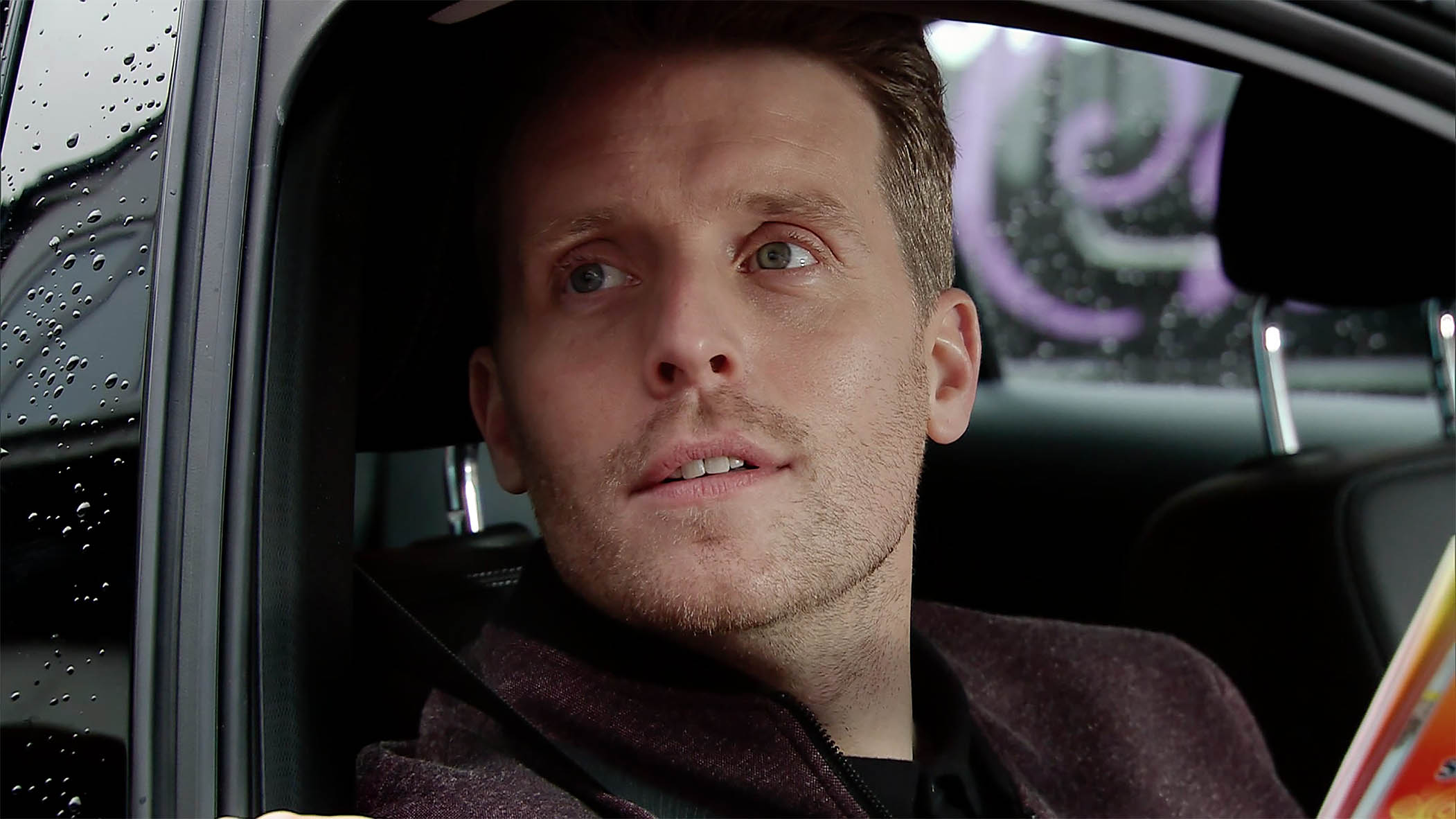 Nathan Curtis in Coronation Street looks shifty as he leans out of a car window