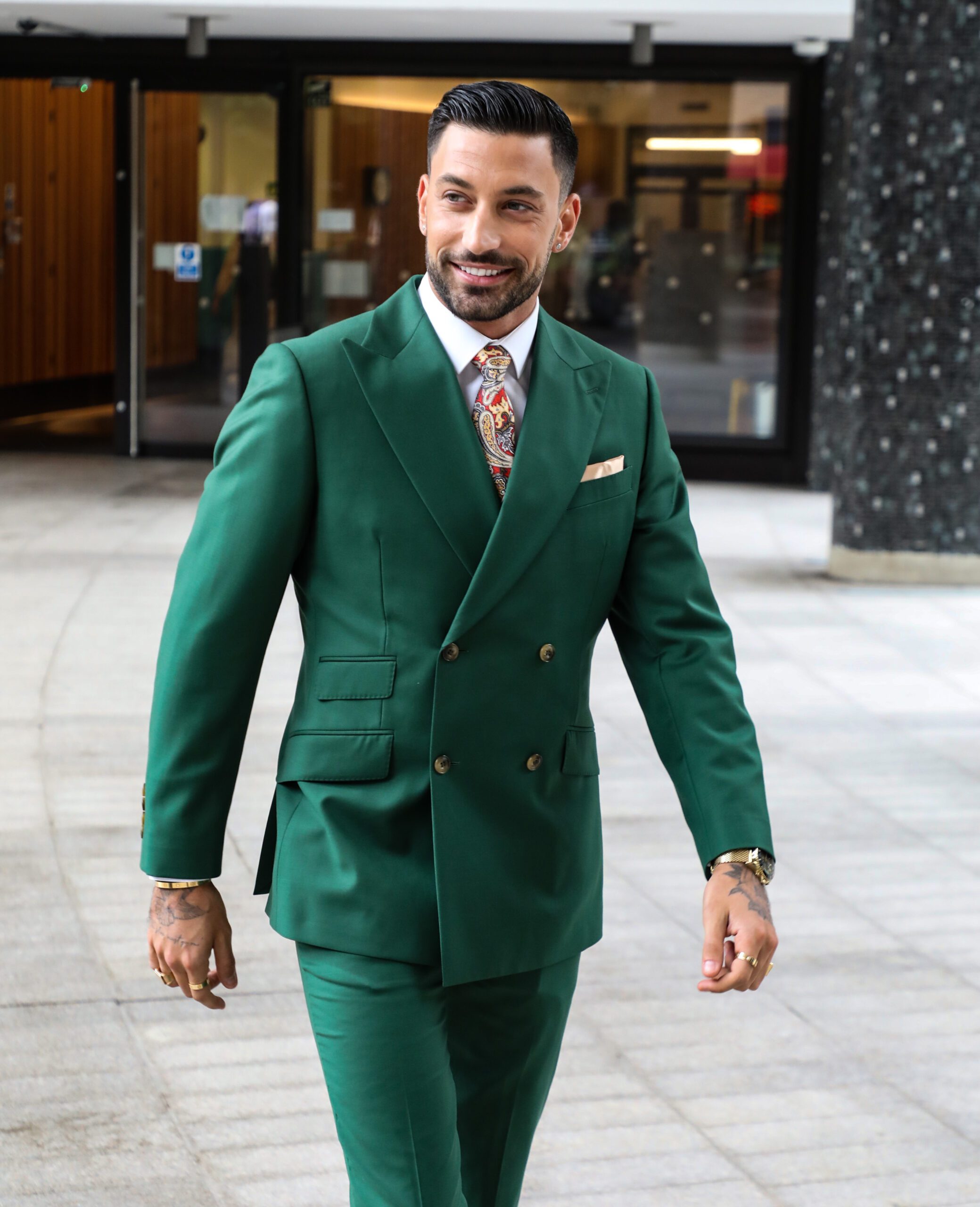 Strictly star Giovanni Pernice smiling whilst wearing green suit