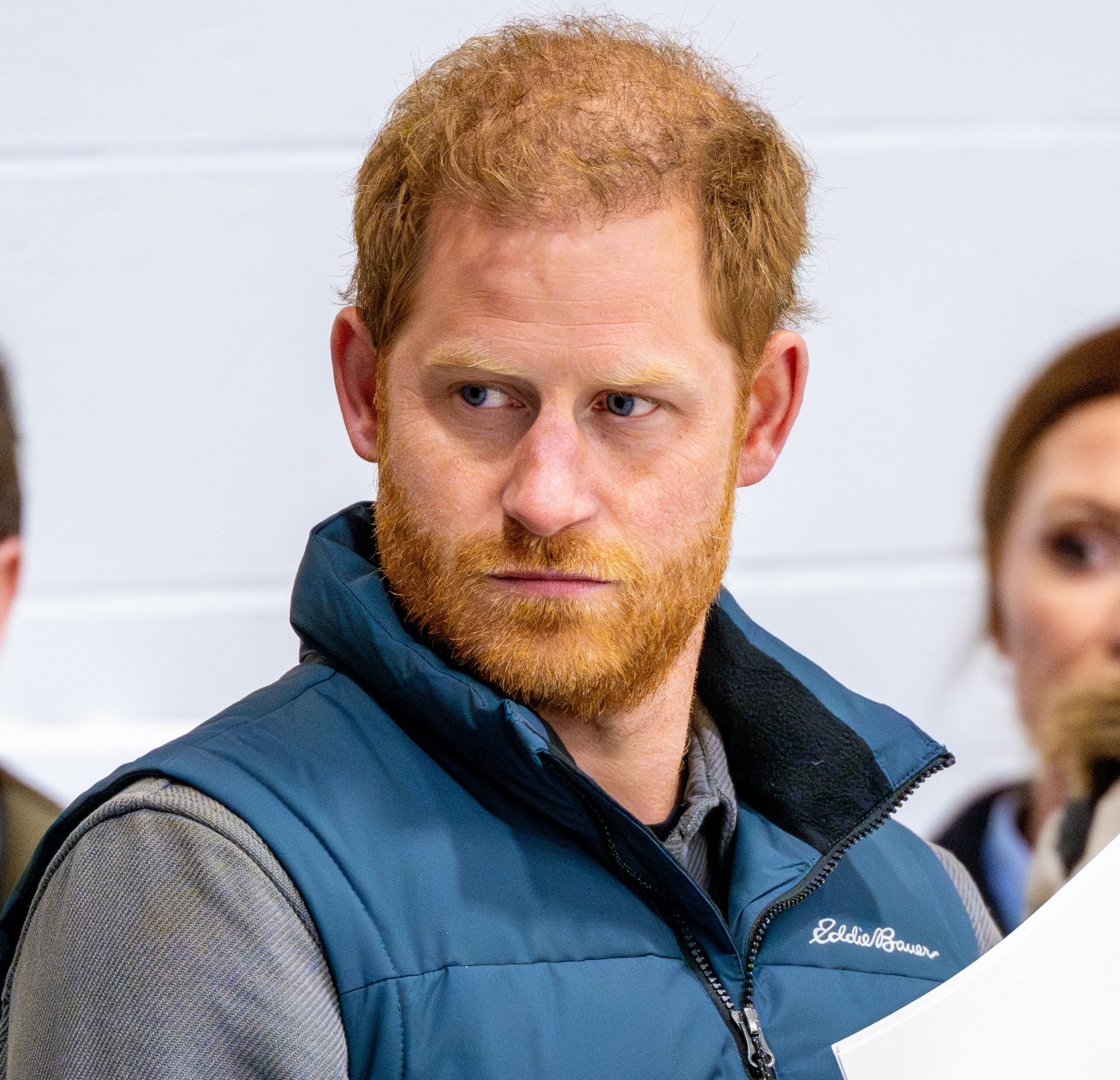 Prince Harry looks to the side serious at event